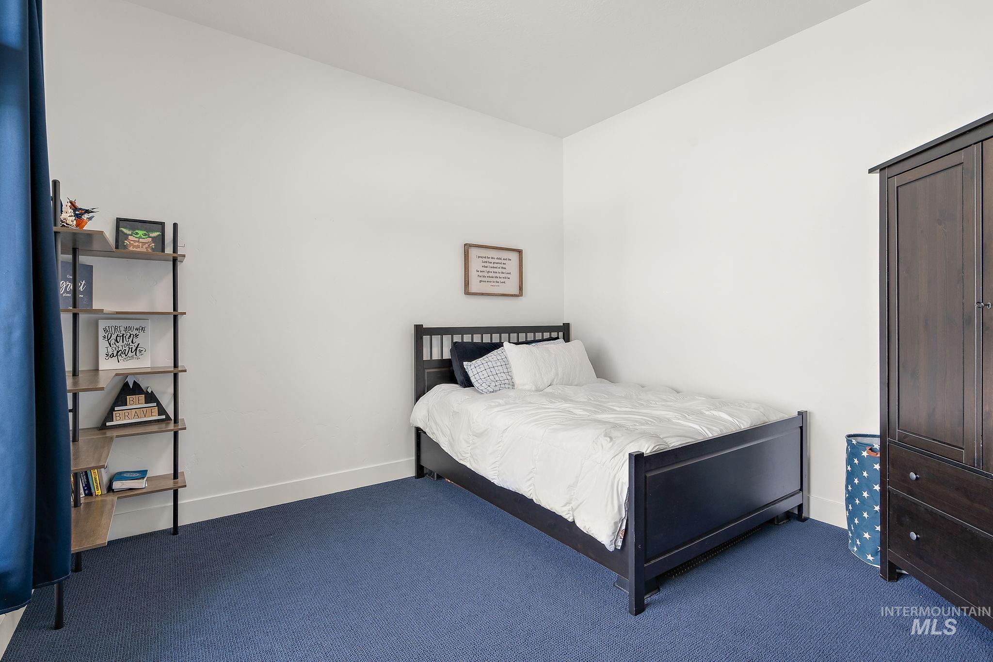 Carpeted bedroom featuring baseboards