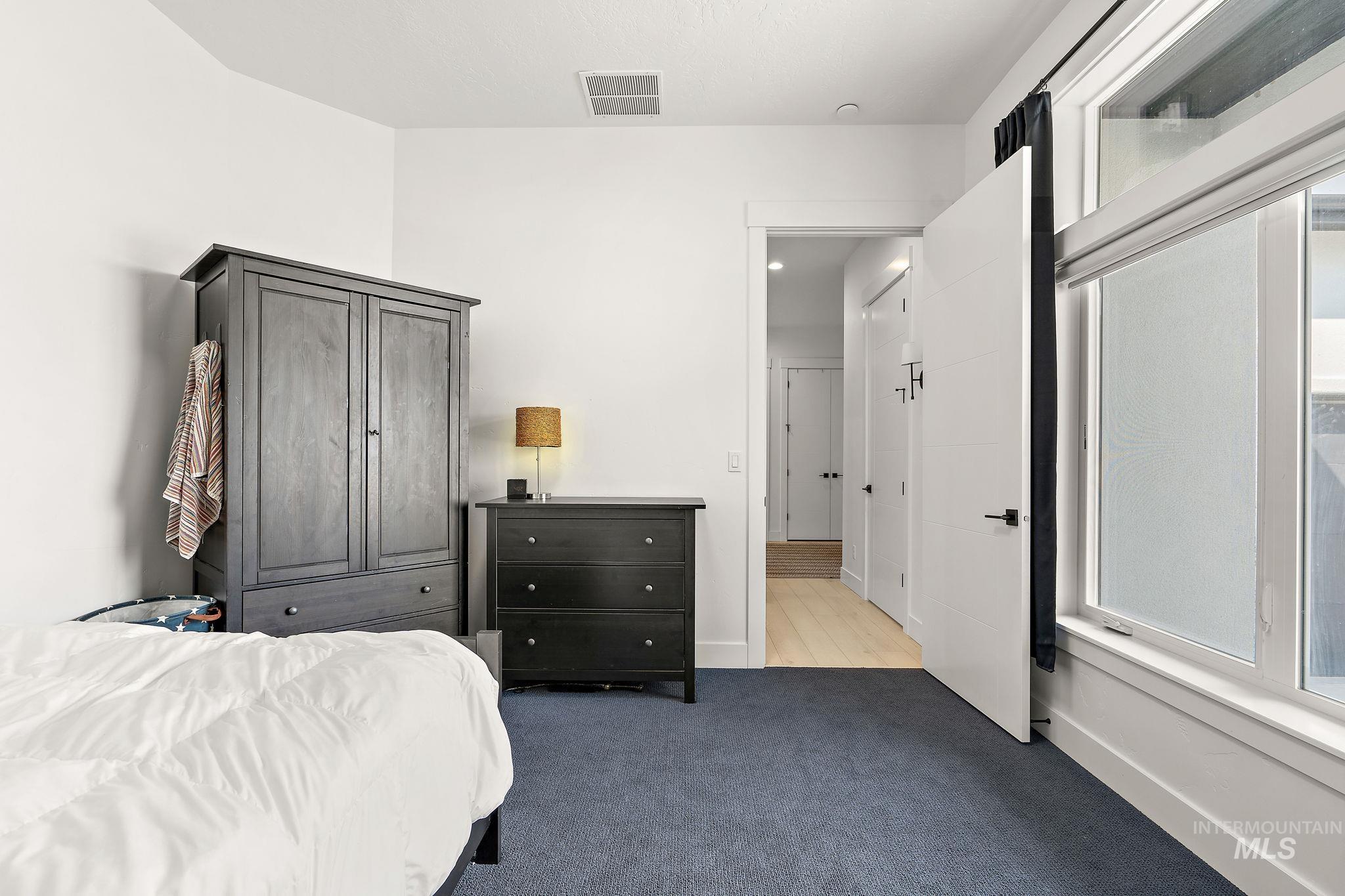 Bedroom with light carpet and baseboards