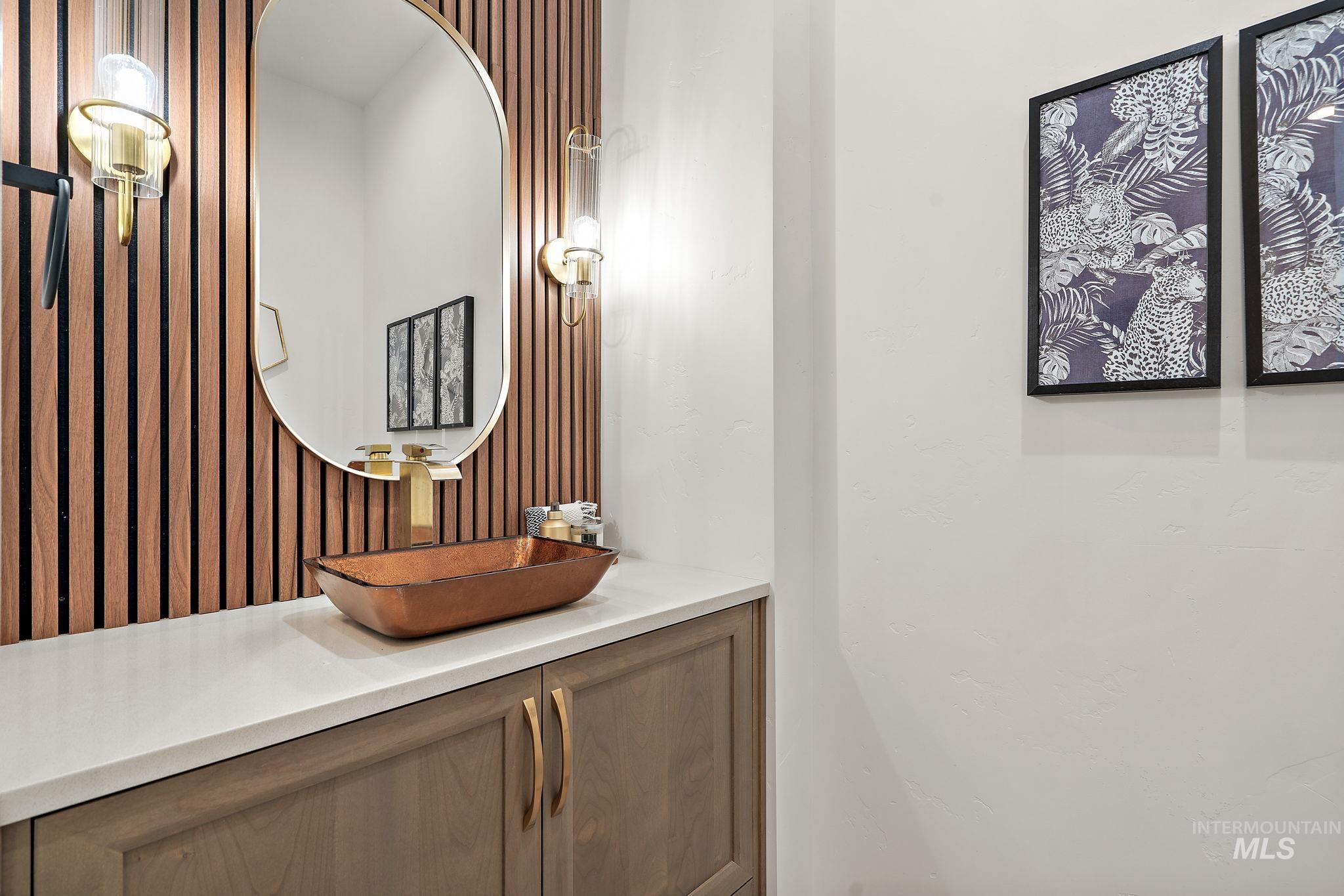Bathroom with vanity and wallpapered walls