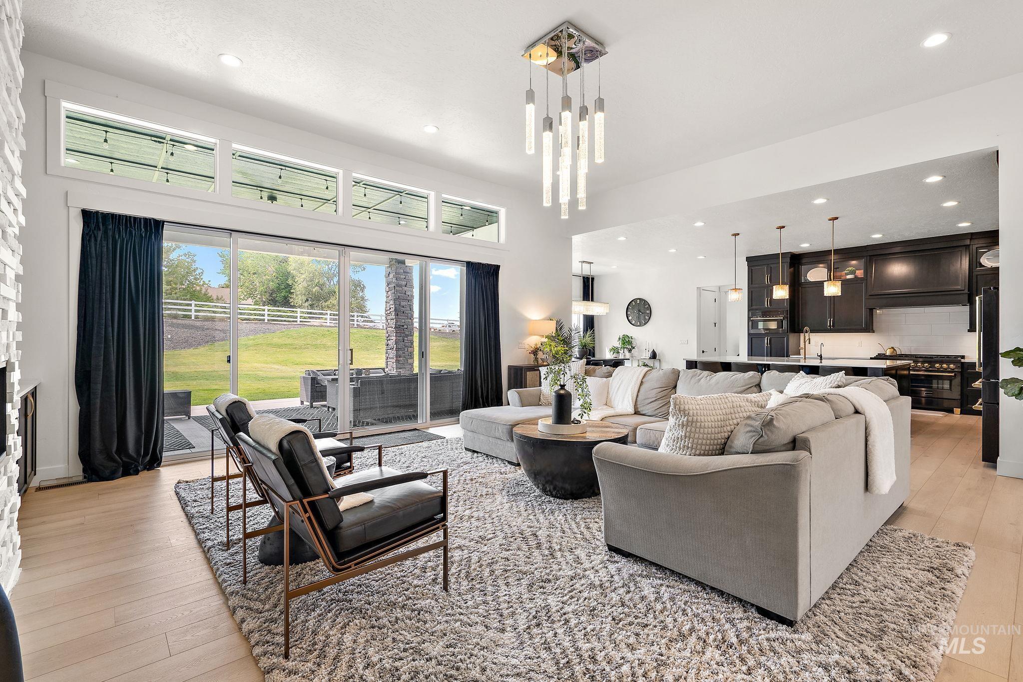 Living room with recessed lighting, light wood-style floors, and a fireplace