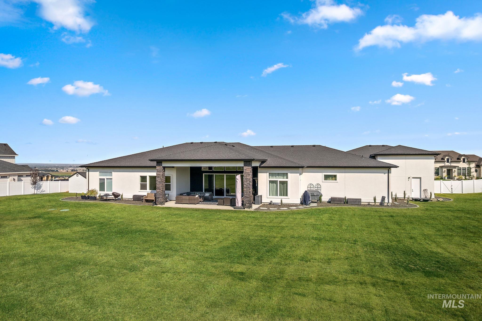Back of property with a patio, an outdoor living space, and stucco siding