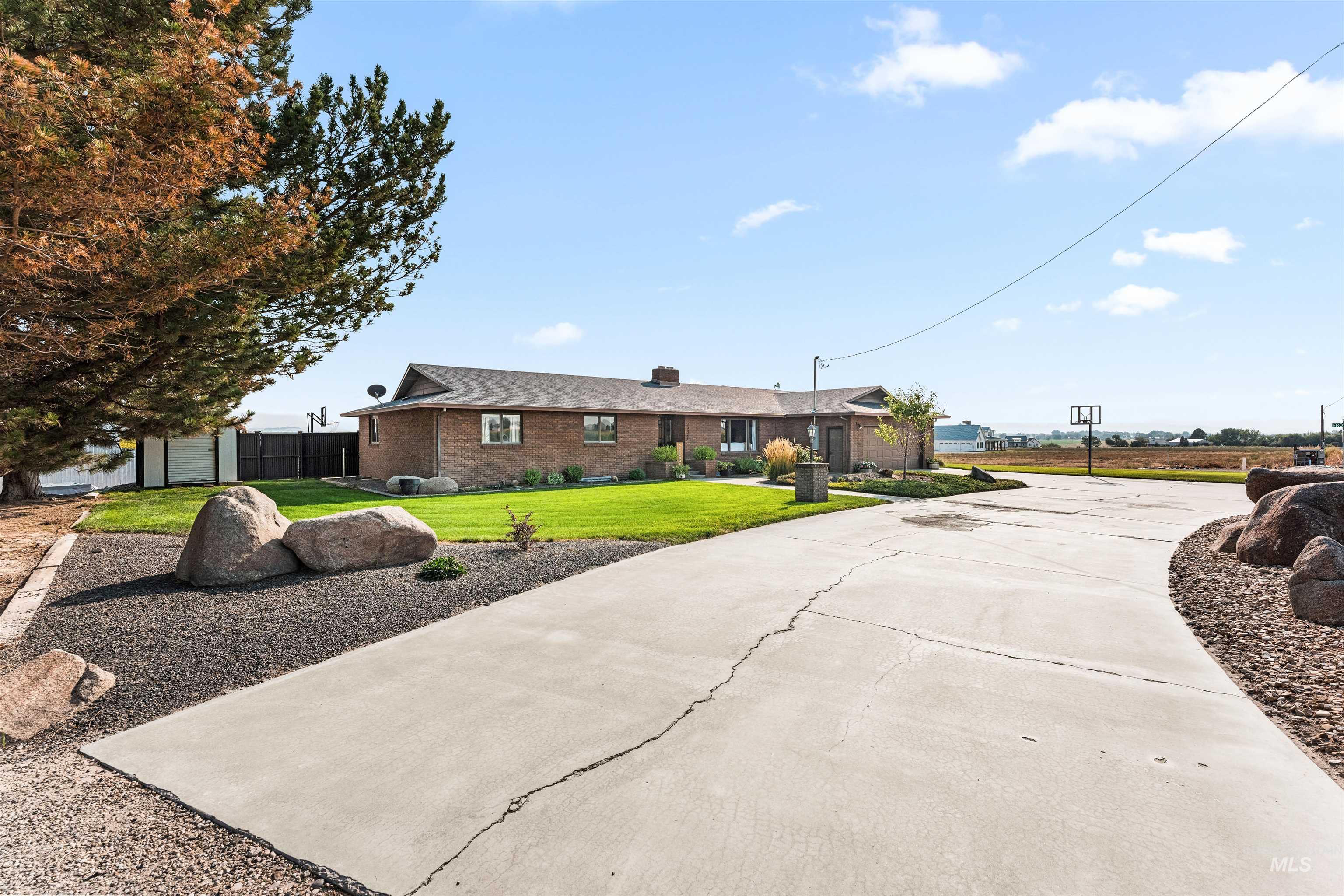 Single story home featuring a front lawn, brick siding, a chimney, and driveway