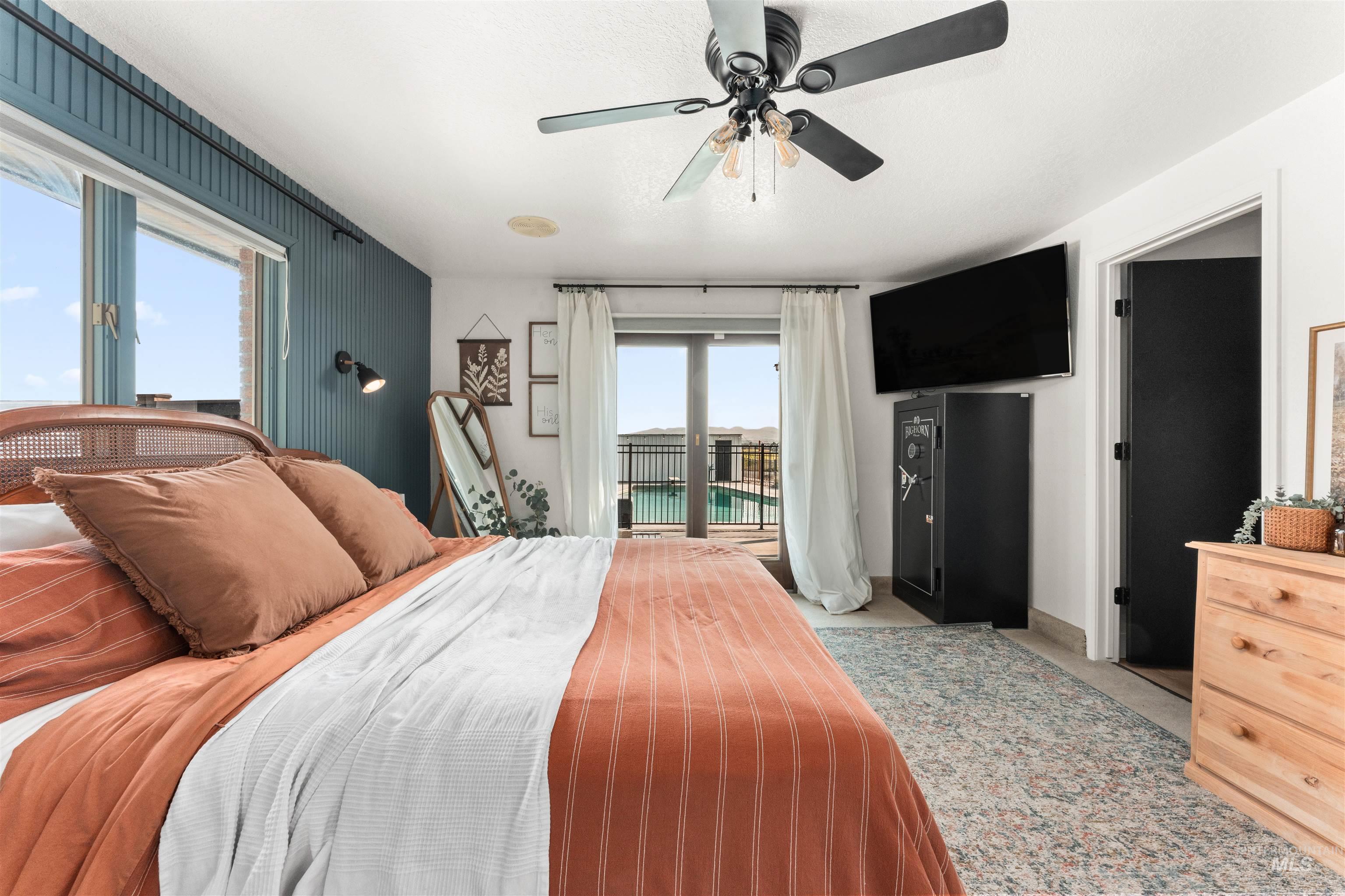 Bedroom featuring access to outside, ceiling fan, and light carpet