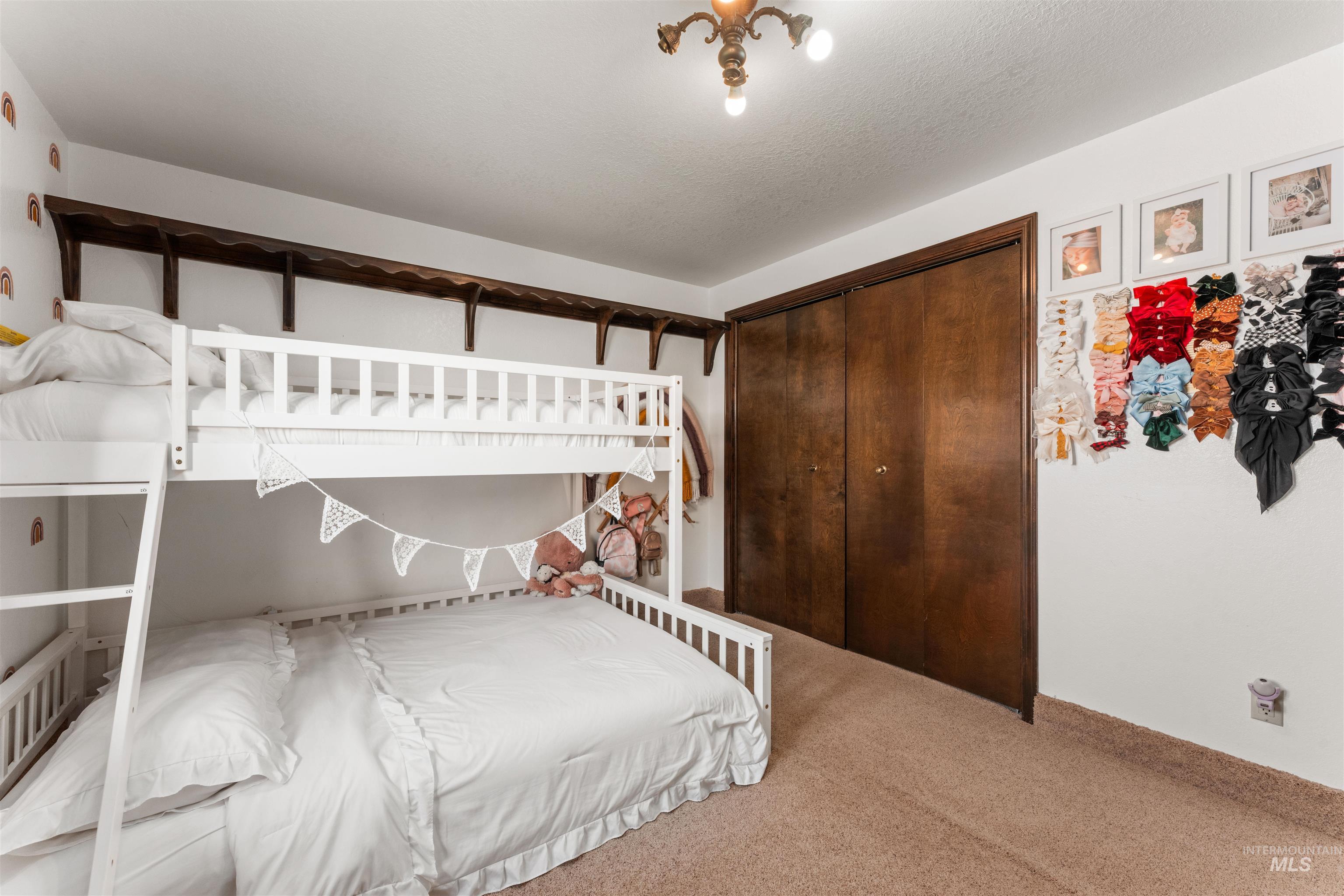 Carpeted bedroom featuring a closet