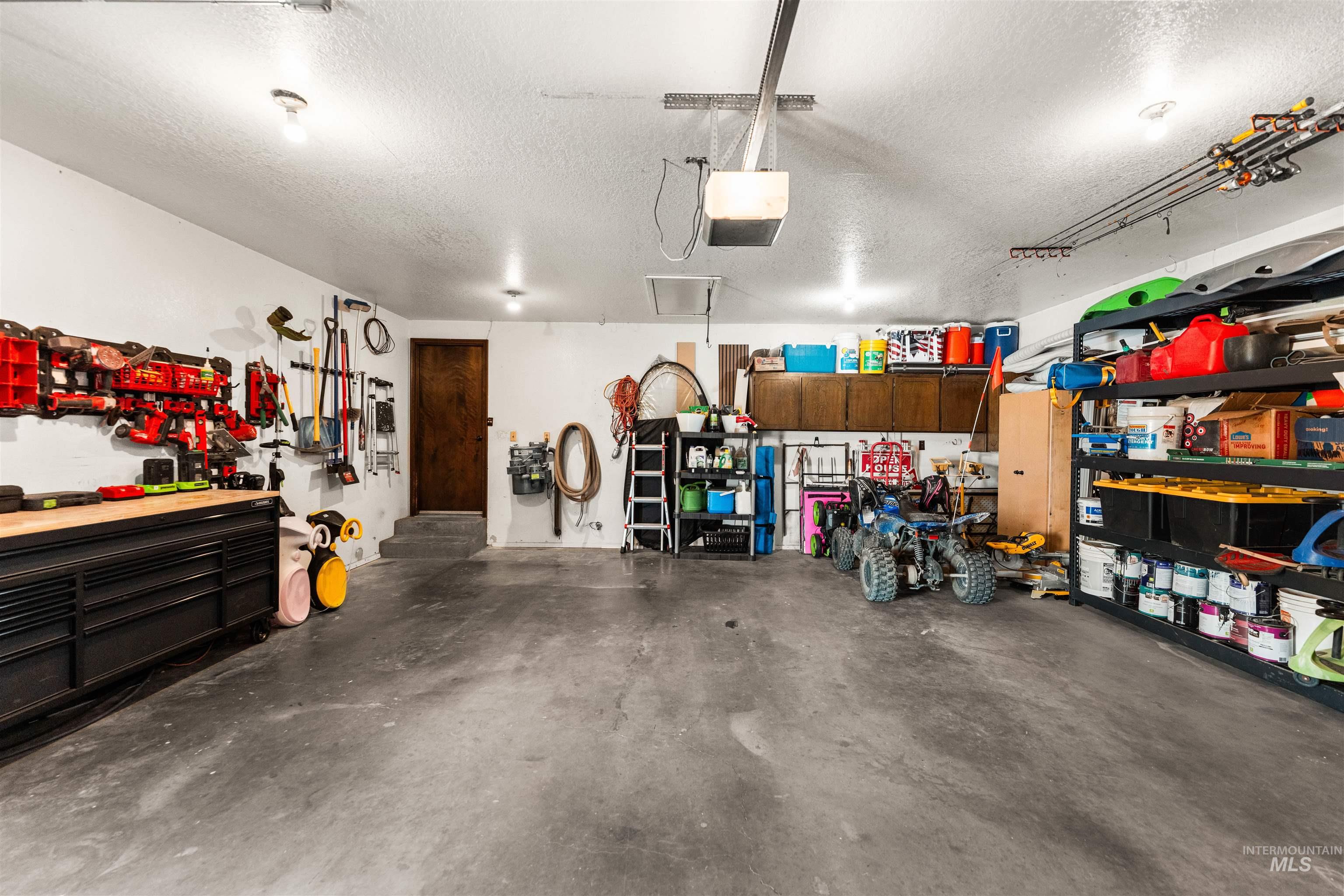 Garage with a workshop area and a garage door opener