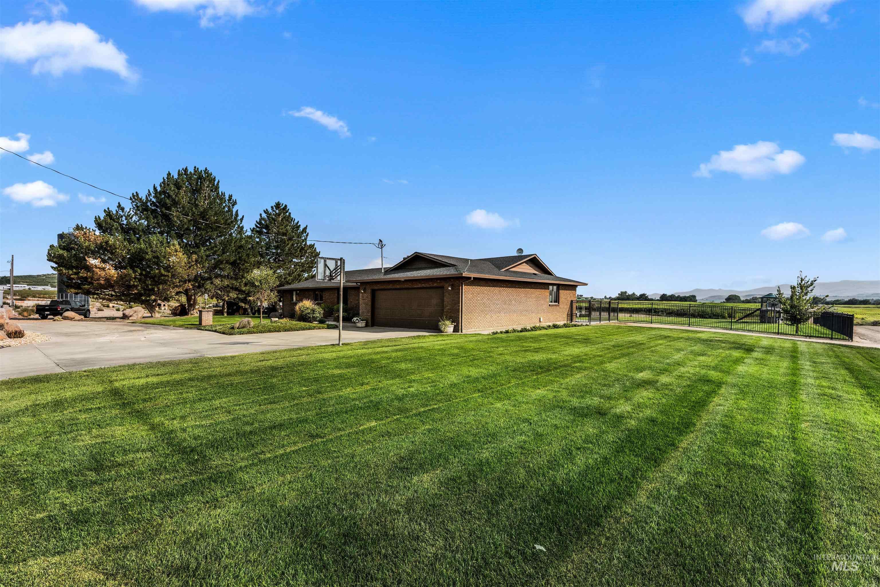View of yard featuring driveway and a garage