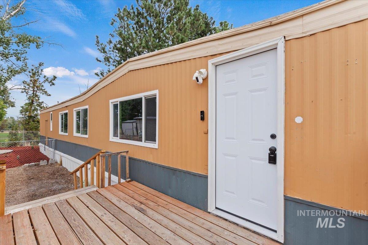 View of exterior entry with a deck