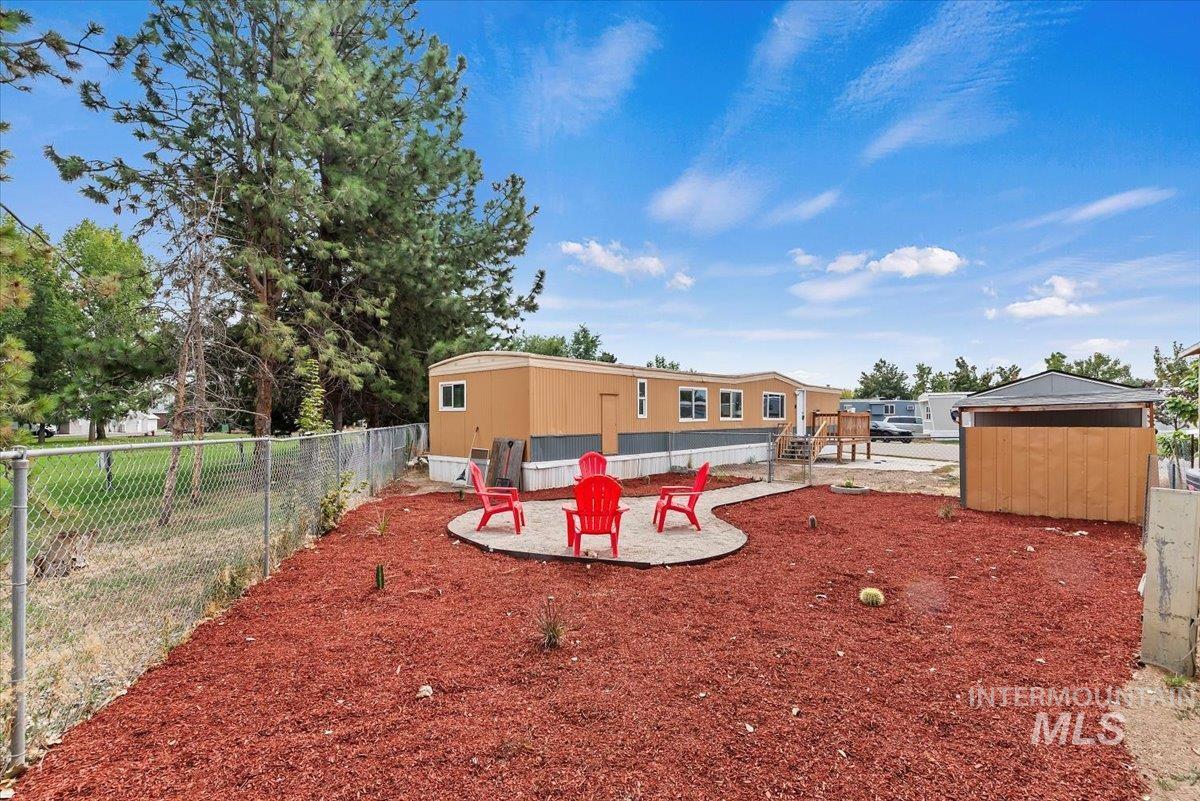 View of yard featuring a patio and an outbuilding