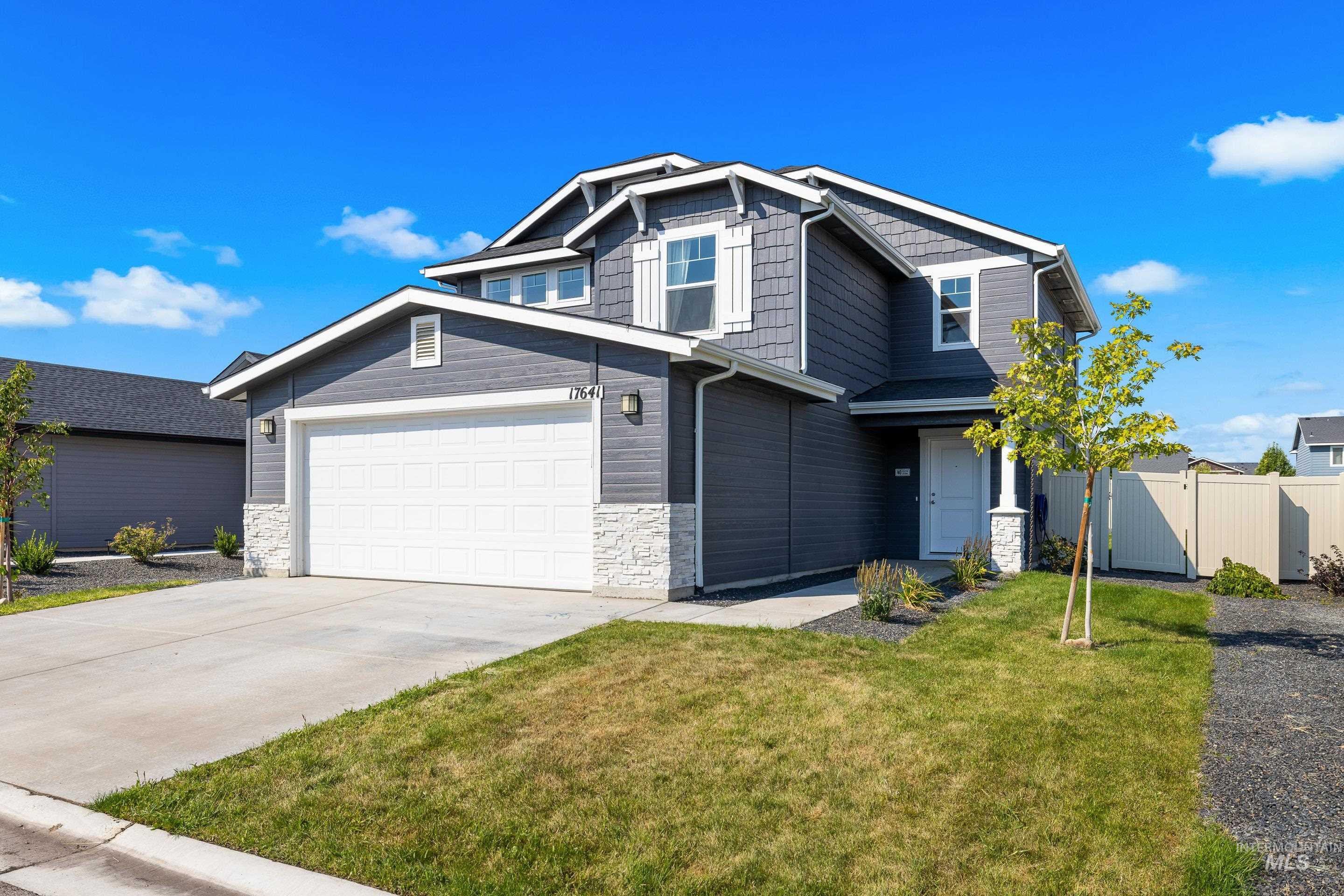 Craftsman house with stone siding and driveway