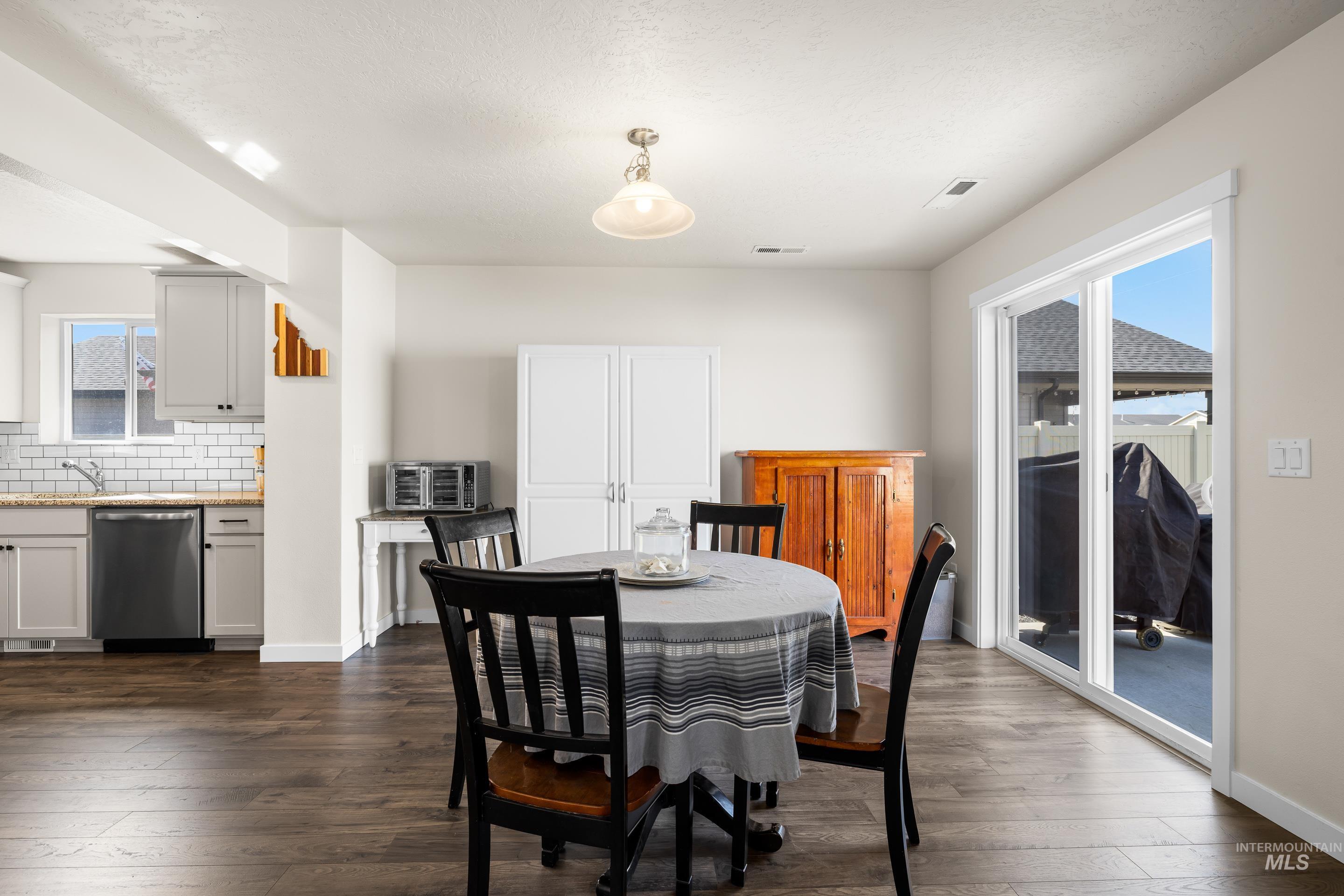 Dining room featuring dark wood finished floors and baseboards