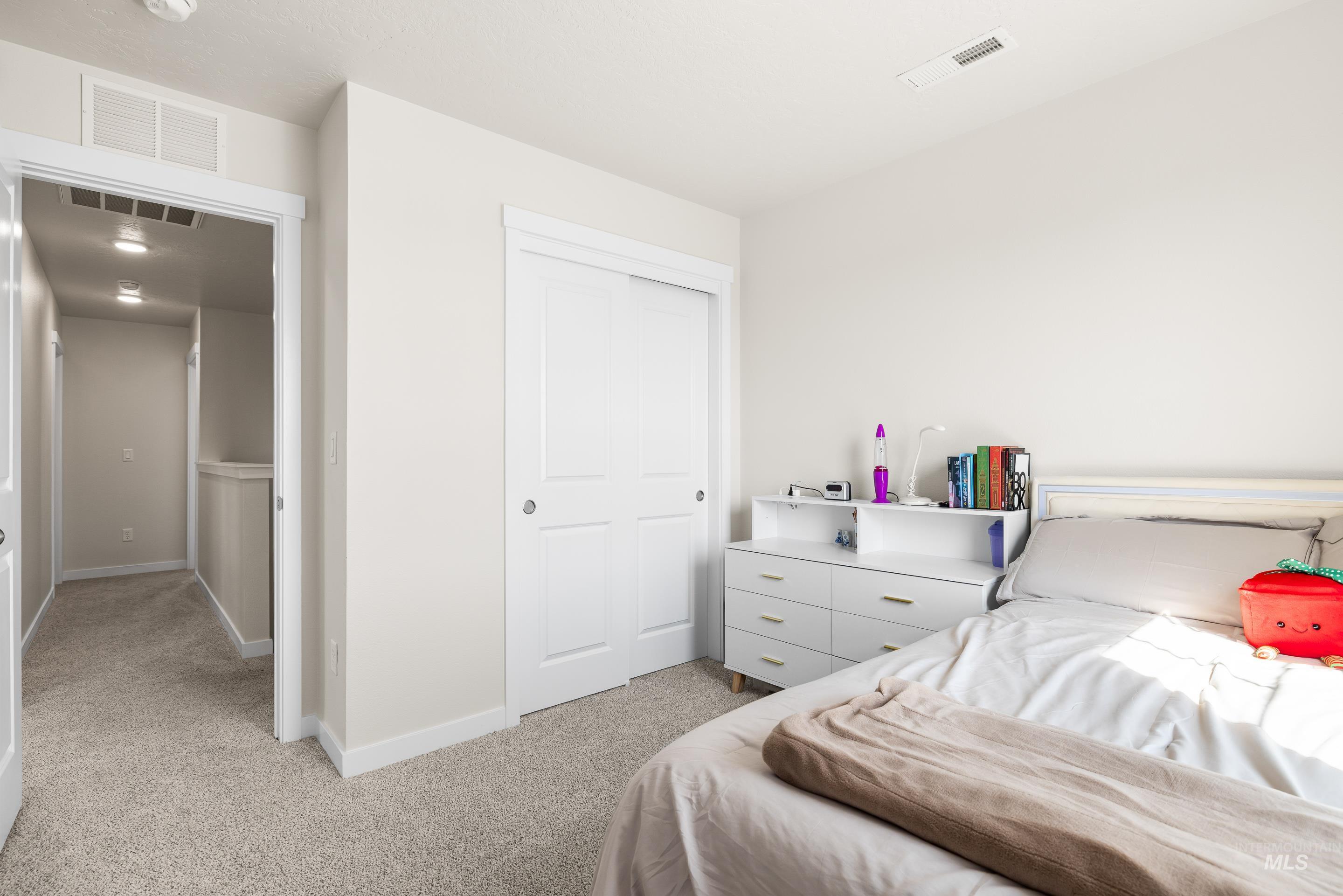 Bedroom featuring a closet and light carpet