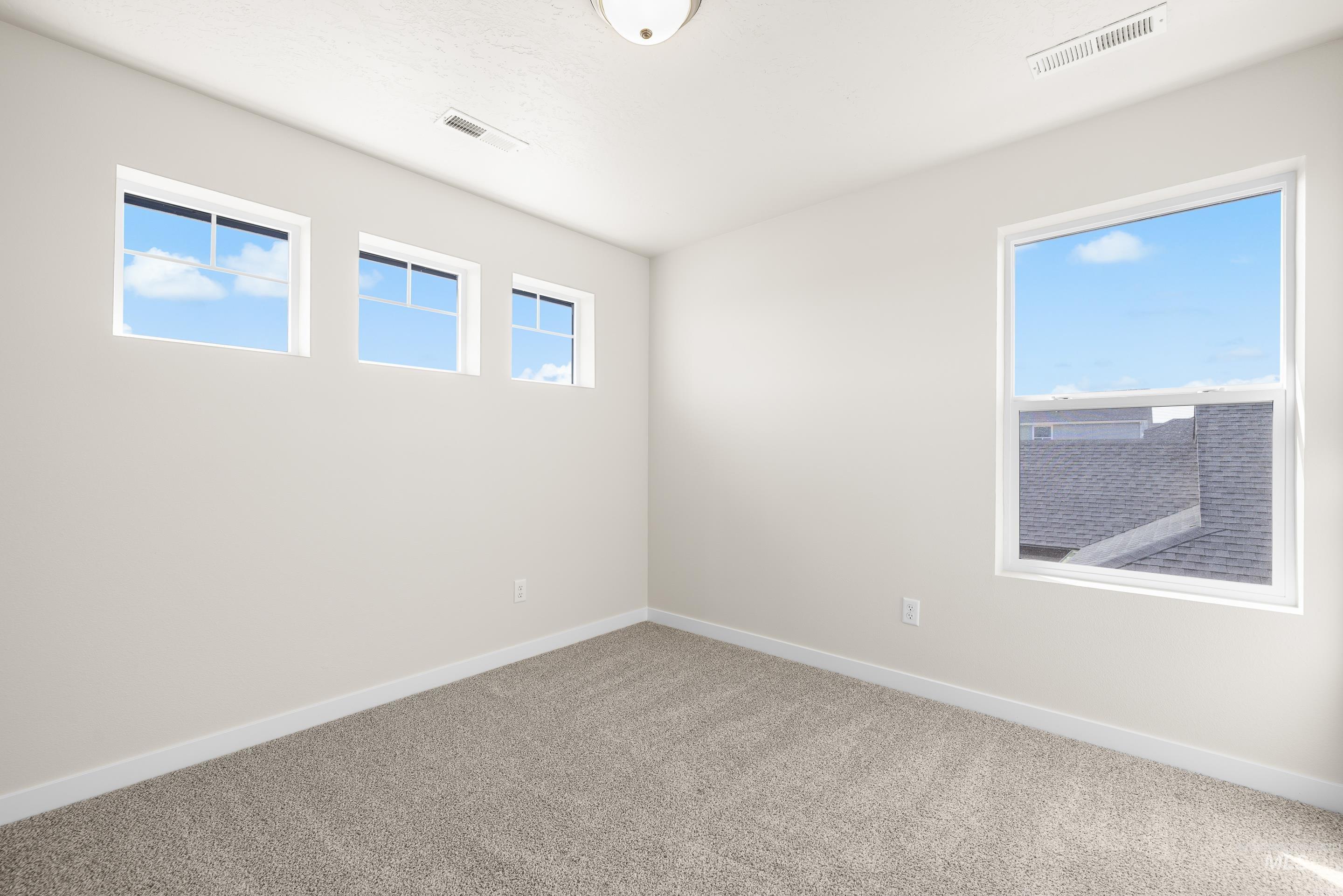 Empty room with carpet flooring and baseboards