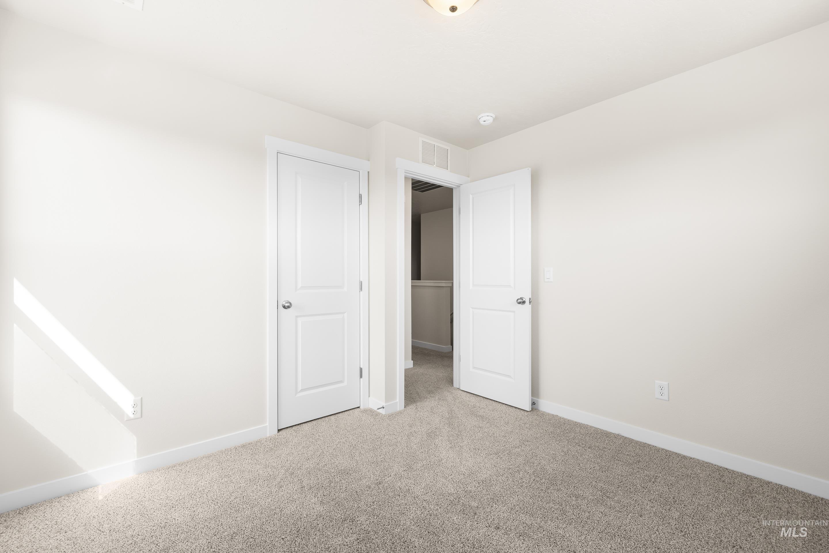 Unfurnished bedroom with carpet and baseboards
