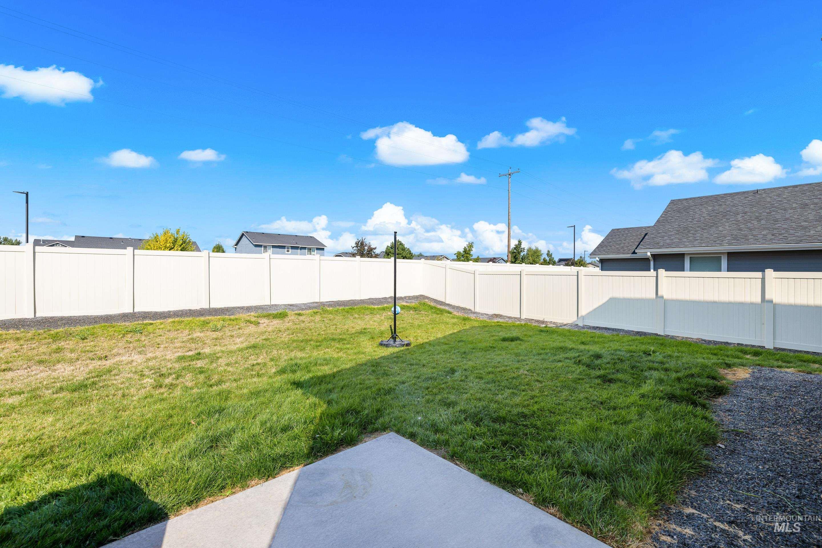 Fenced backyard featuring a patio