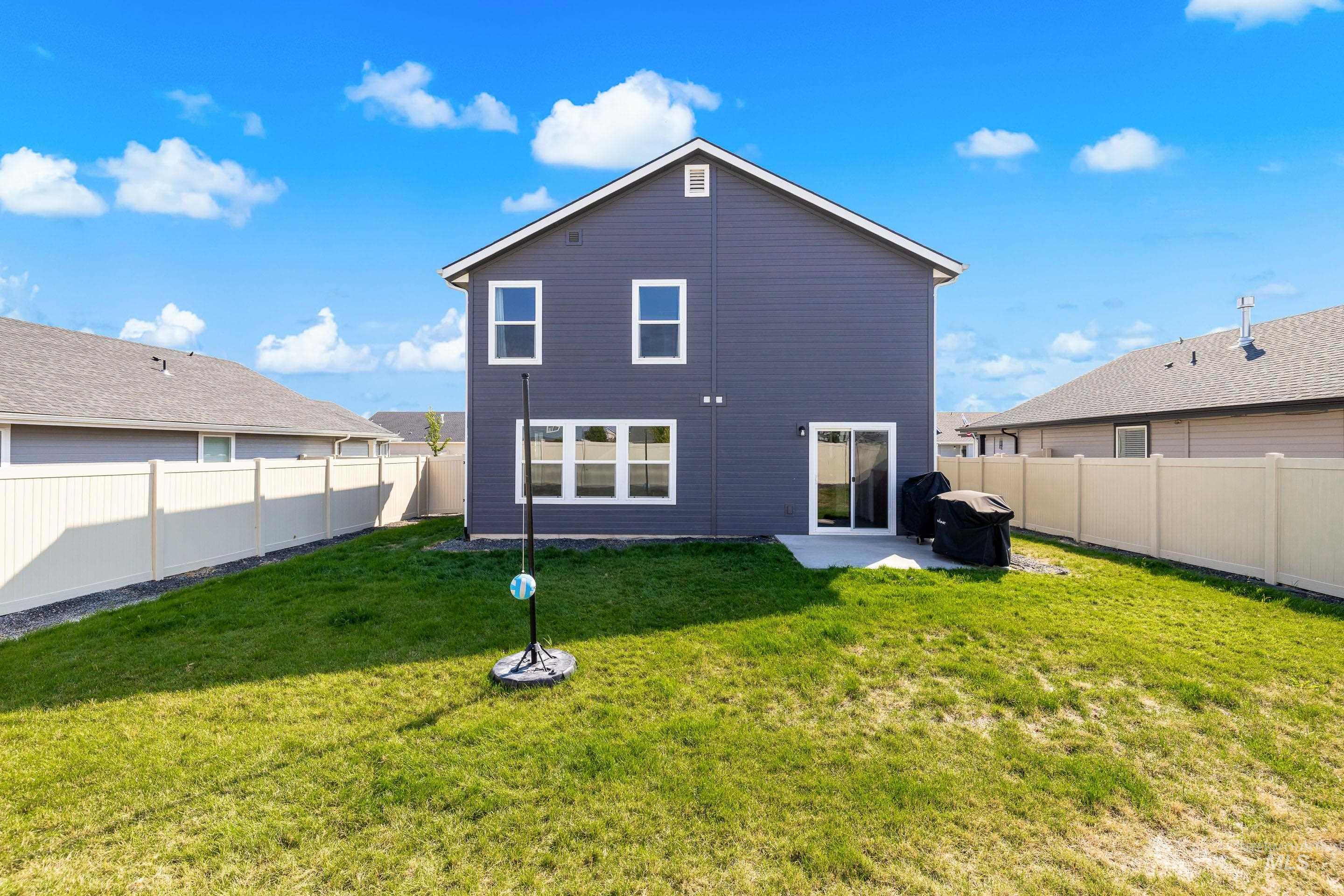 Back of property featuring a patio and a fenced backyard