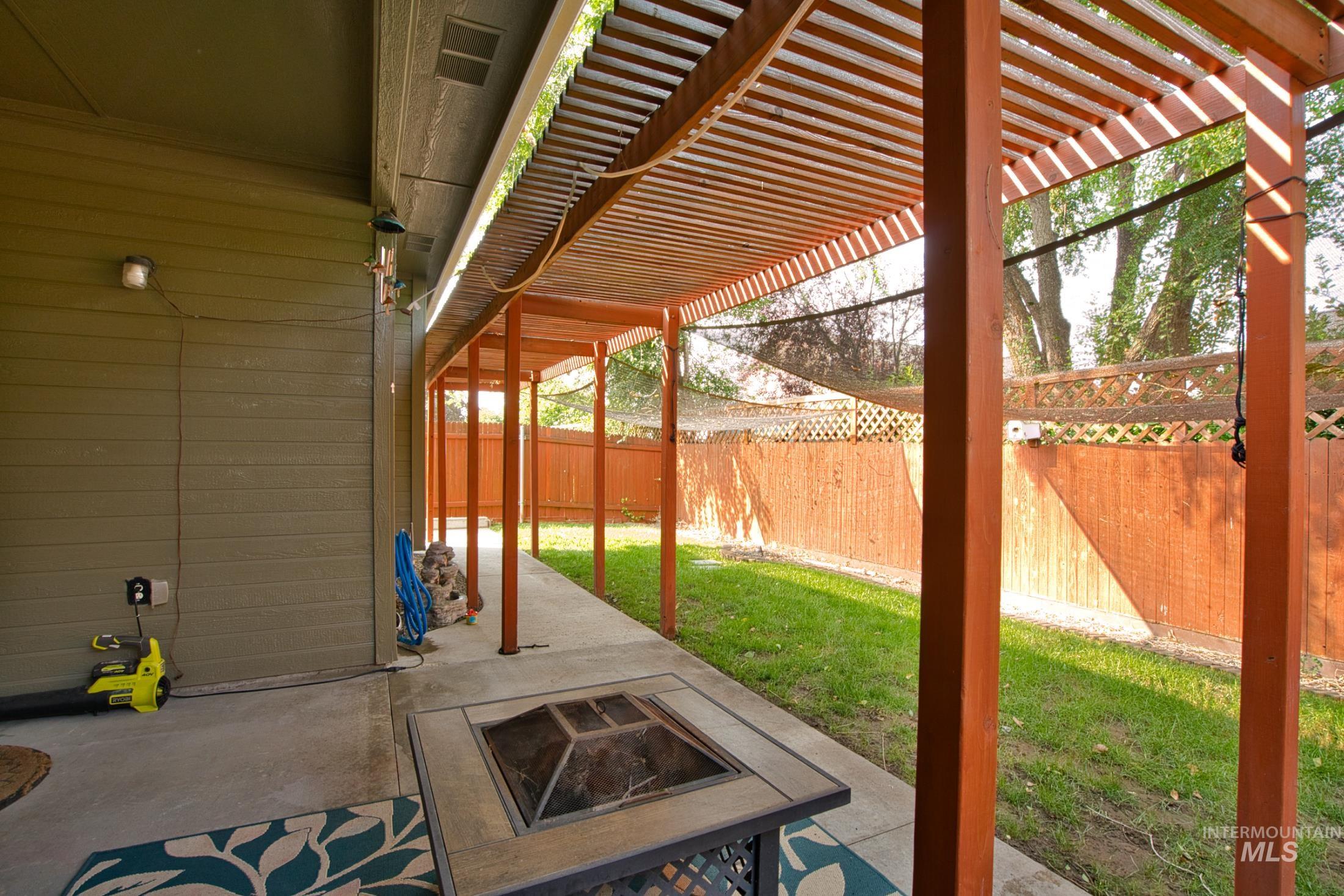 Fenced backyard with a patio area and a pergola