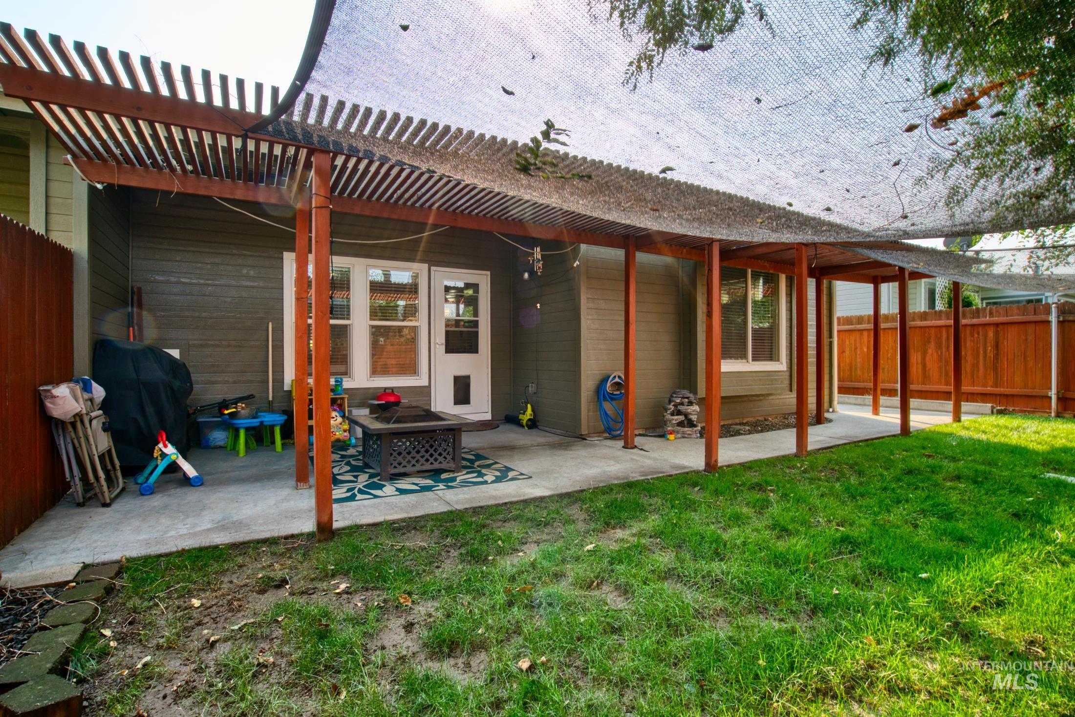 Back of property with a patio area and a pergola