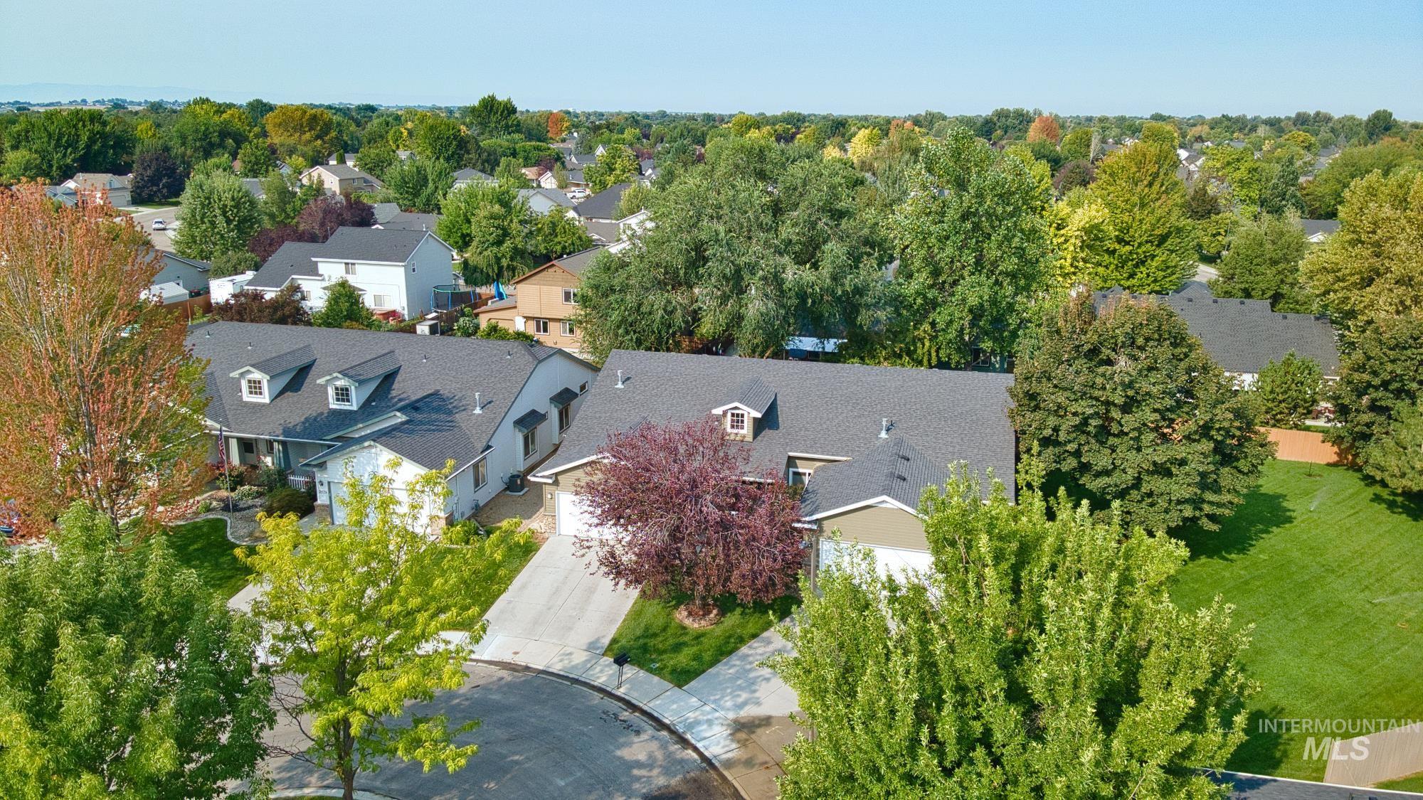Aerial perspective of suburban area with a tree filled landscape