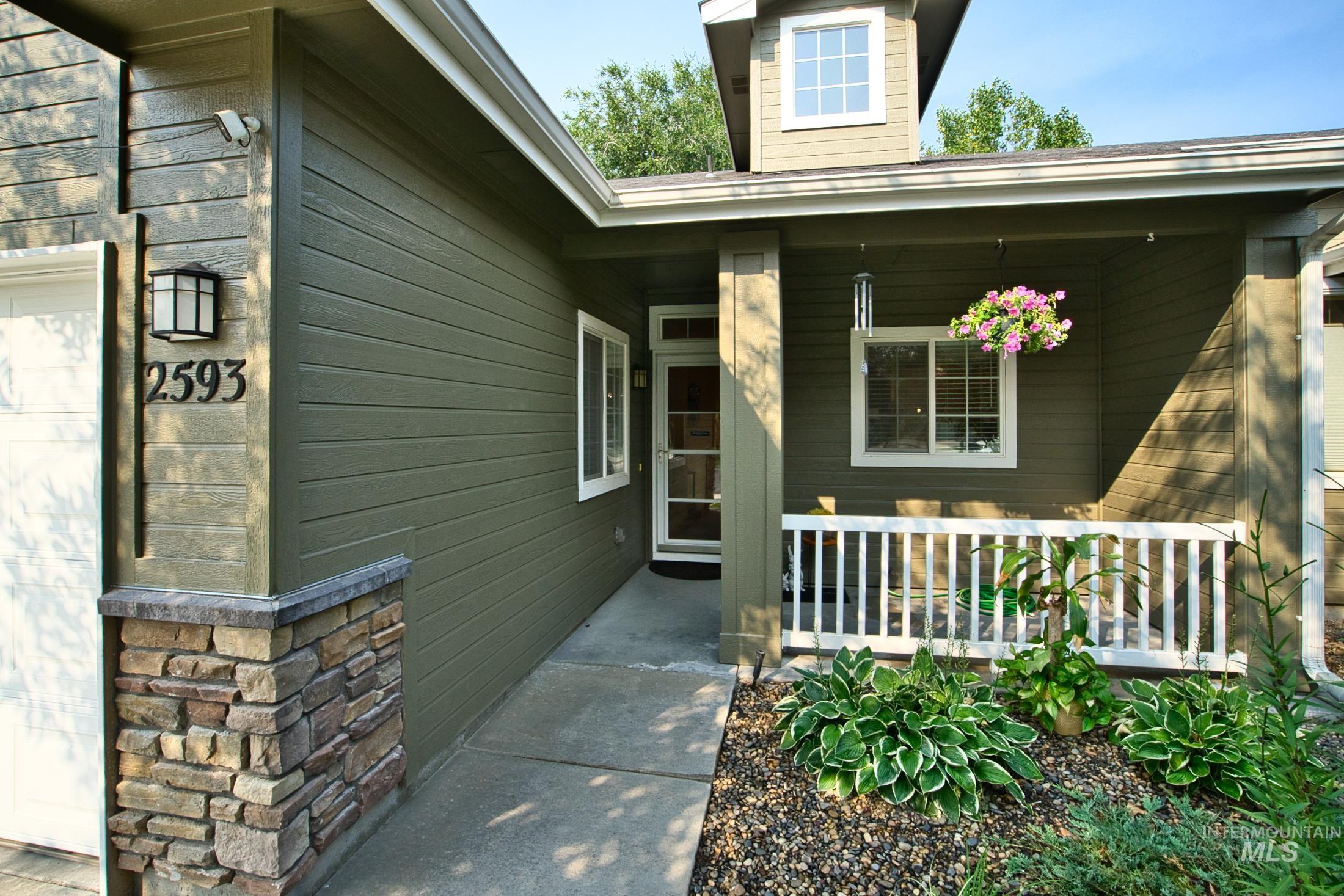 View of exterior entry with a porch and an attached garage