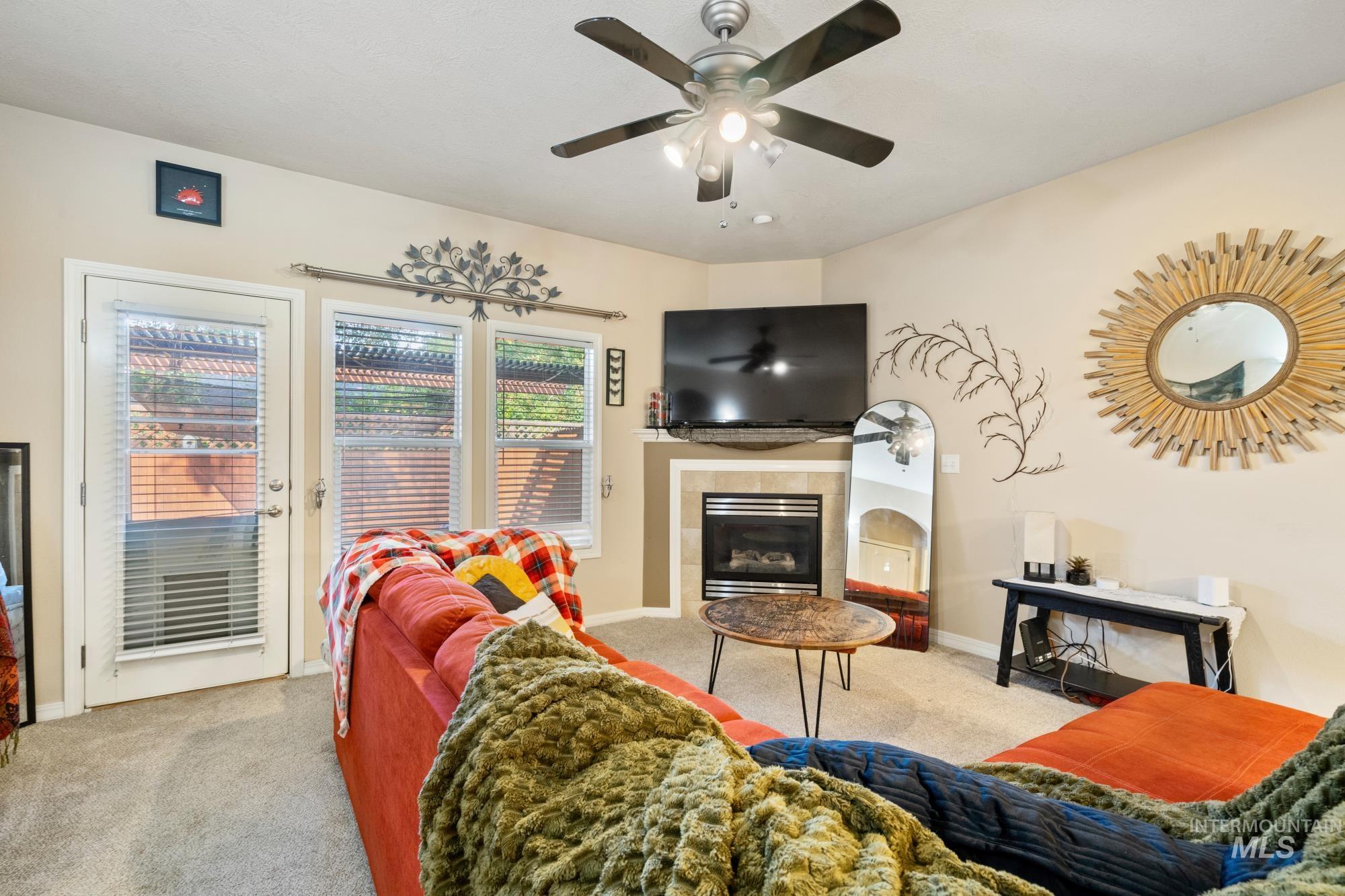 Living room featuring carpet flooring and a fireplace