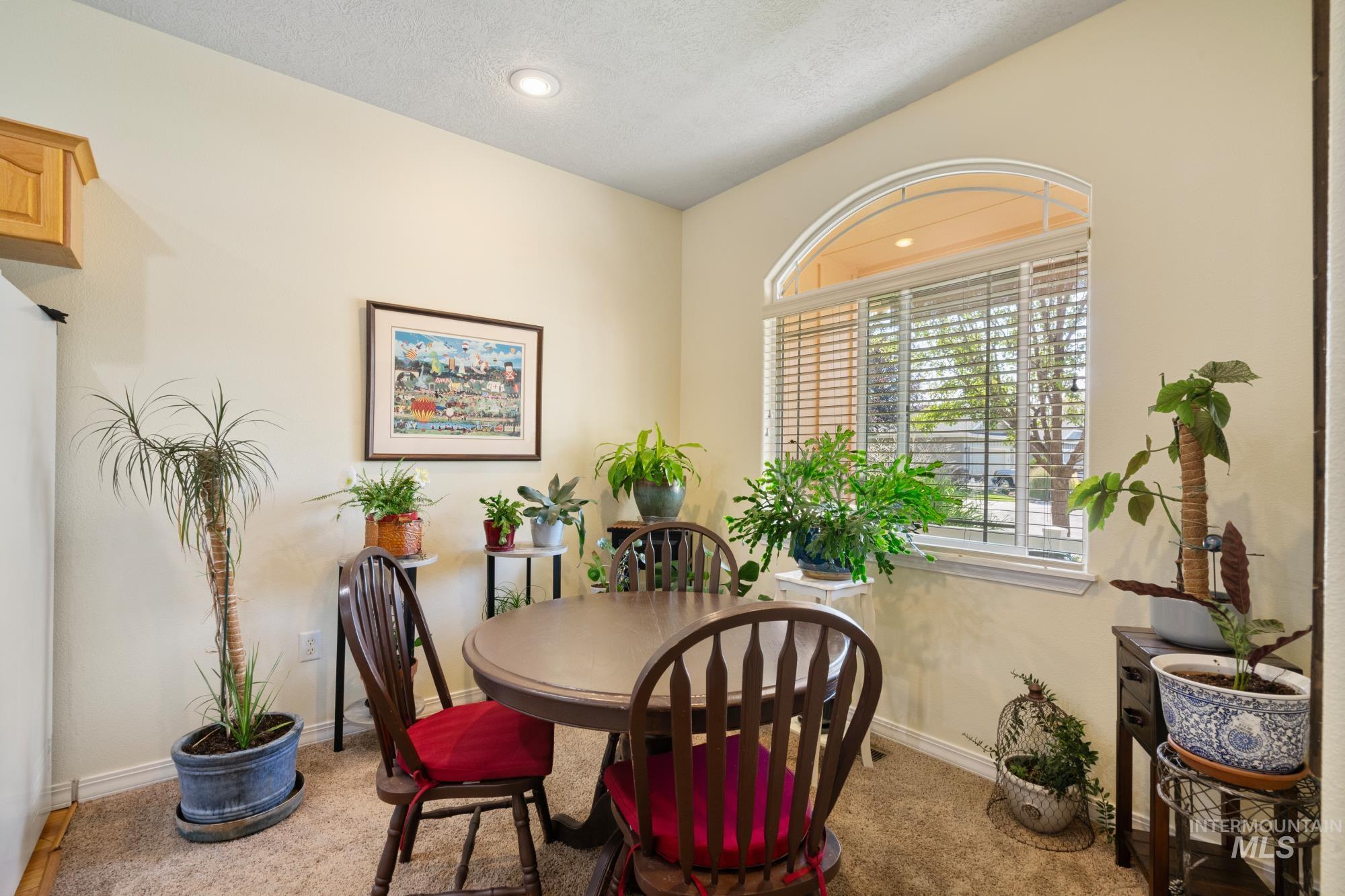 Carpeted dining room with recessed lighting and a textured ceiling