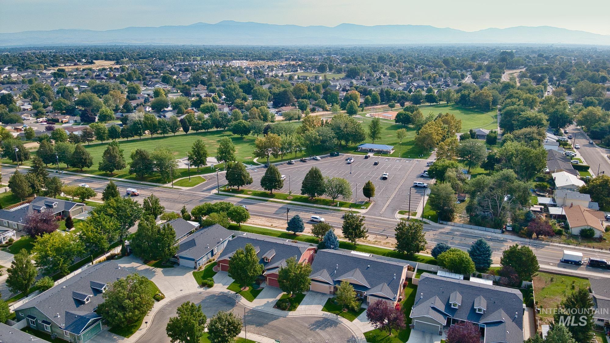Aerial view of residential area featuring a mountainous background