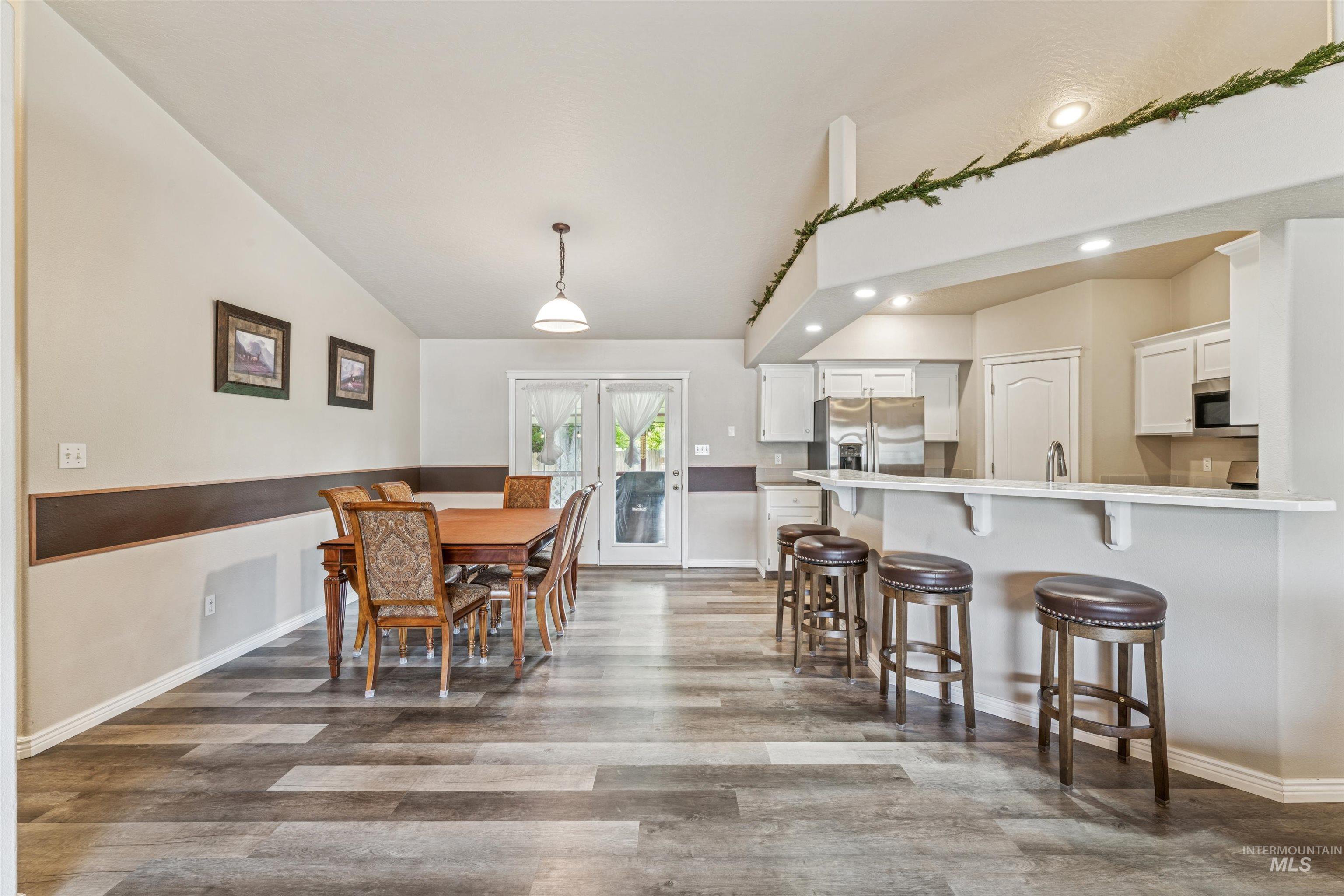 Dining room featuring recessed lighting, light wood-type flooring, and french doors