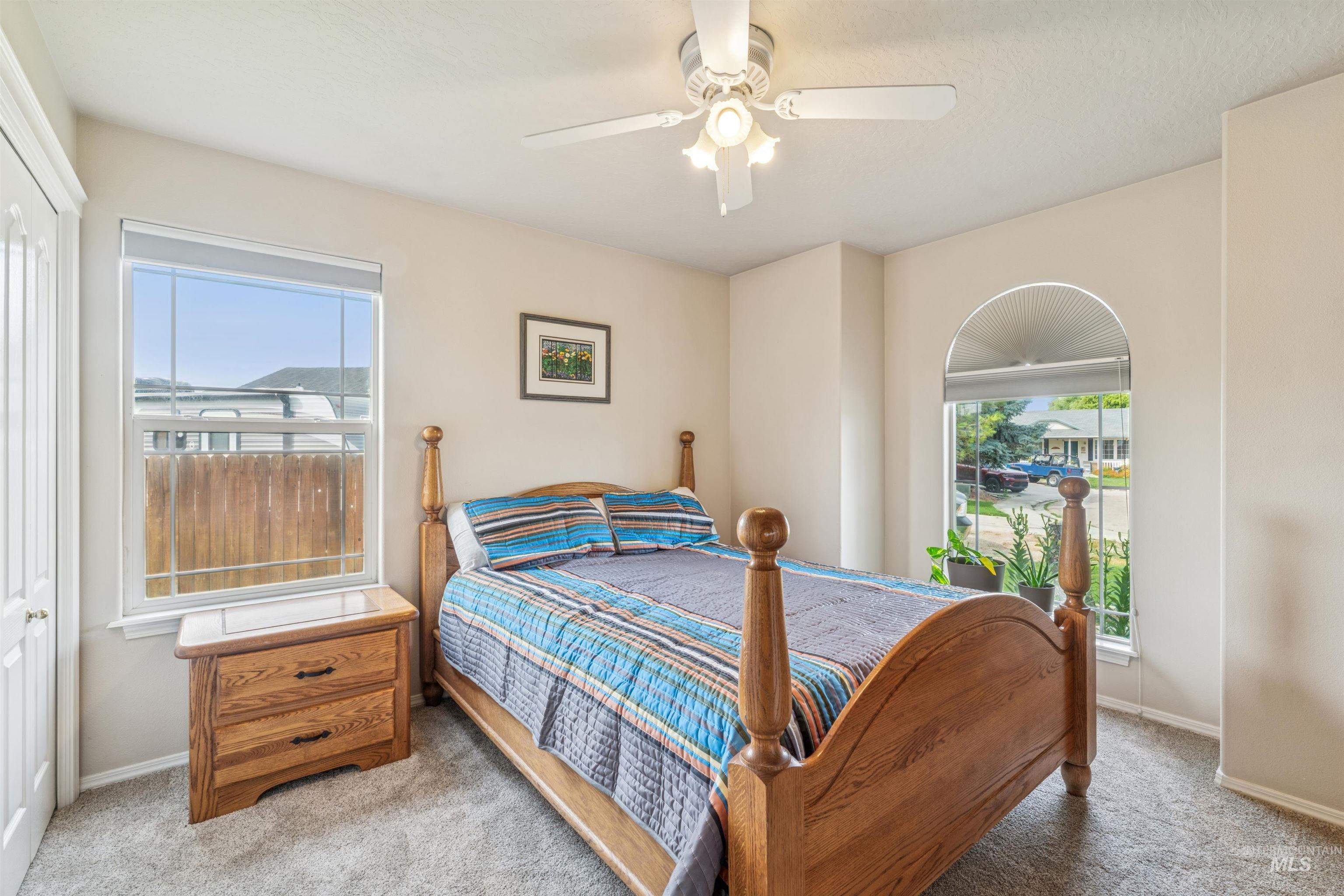 Bedroom featuring light carpet and ceiling fan