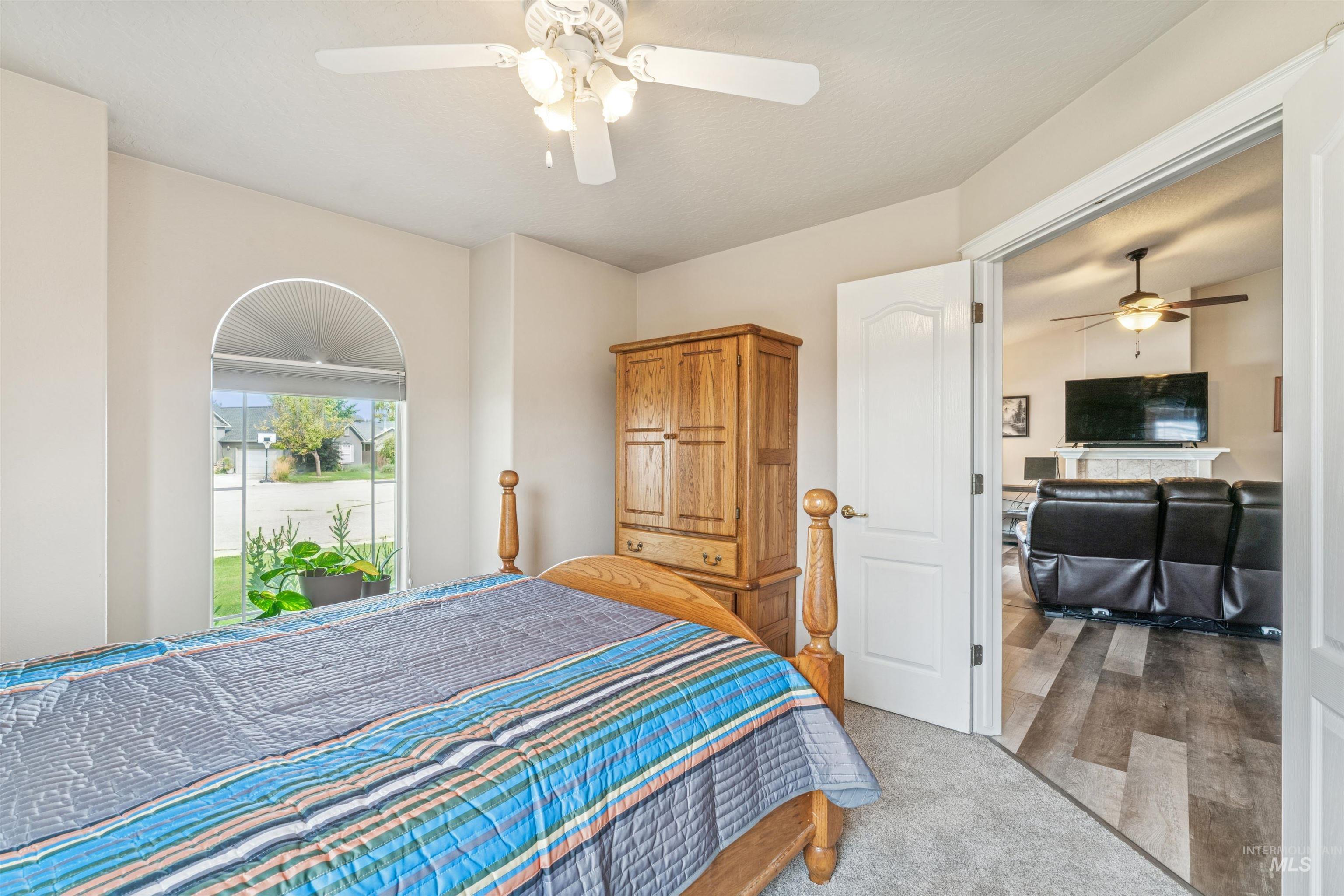 Bedroom featuring light carpet and ceiling fan