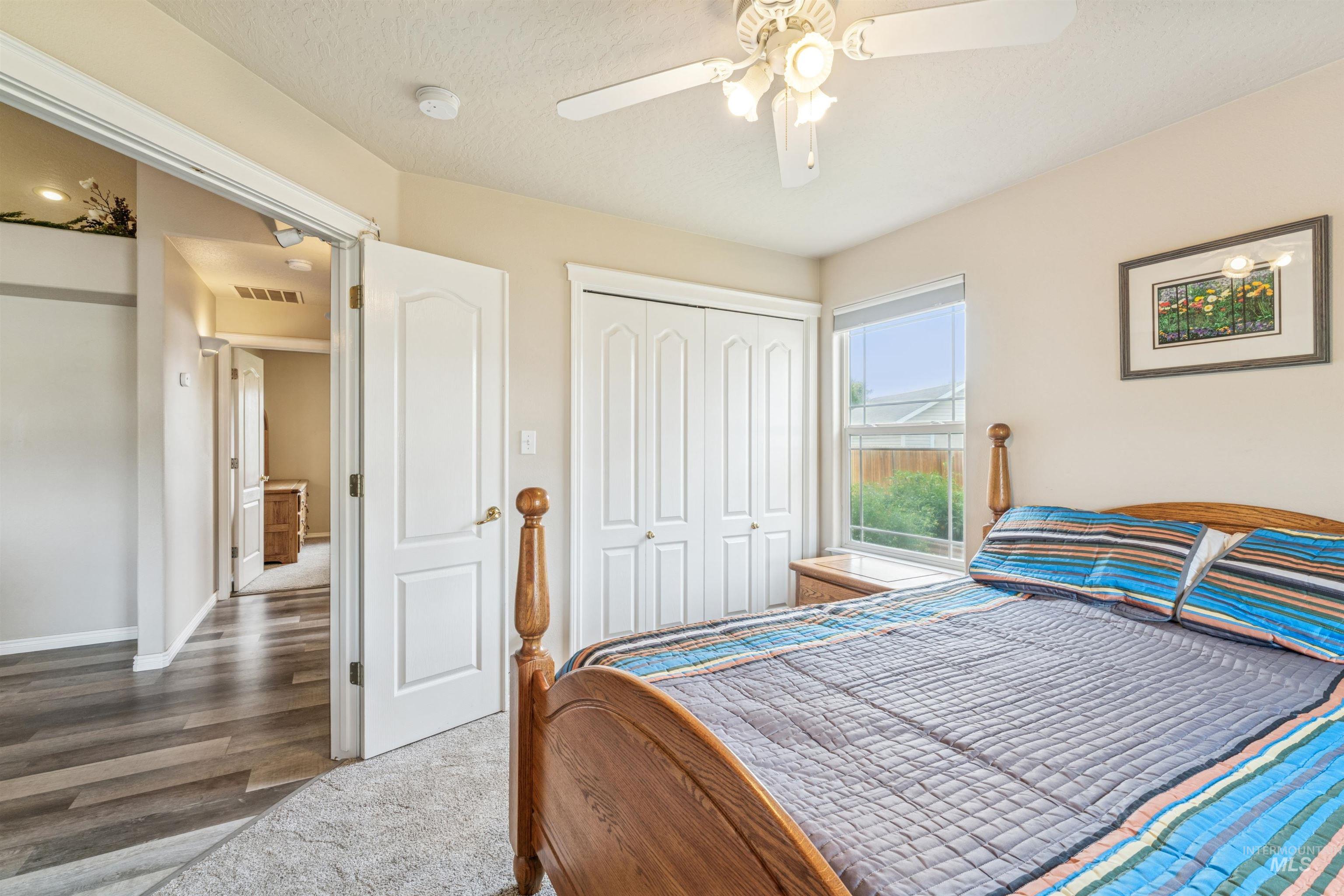 Bedroom featuring a closet, ceiling fan, and carpet flooring