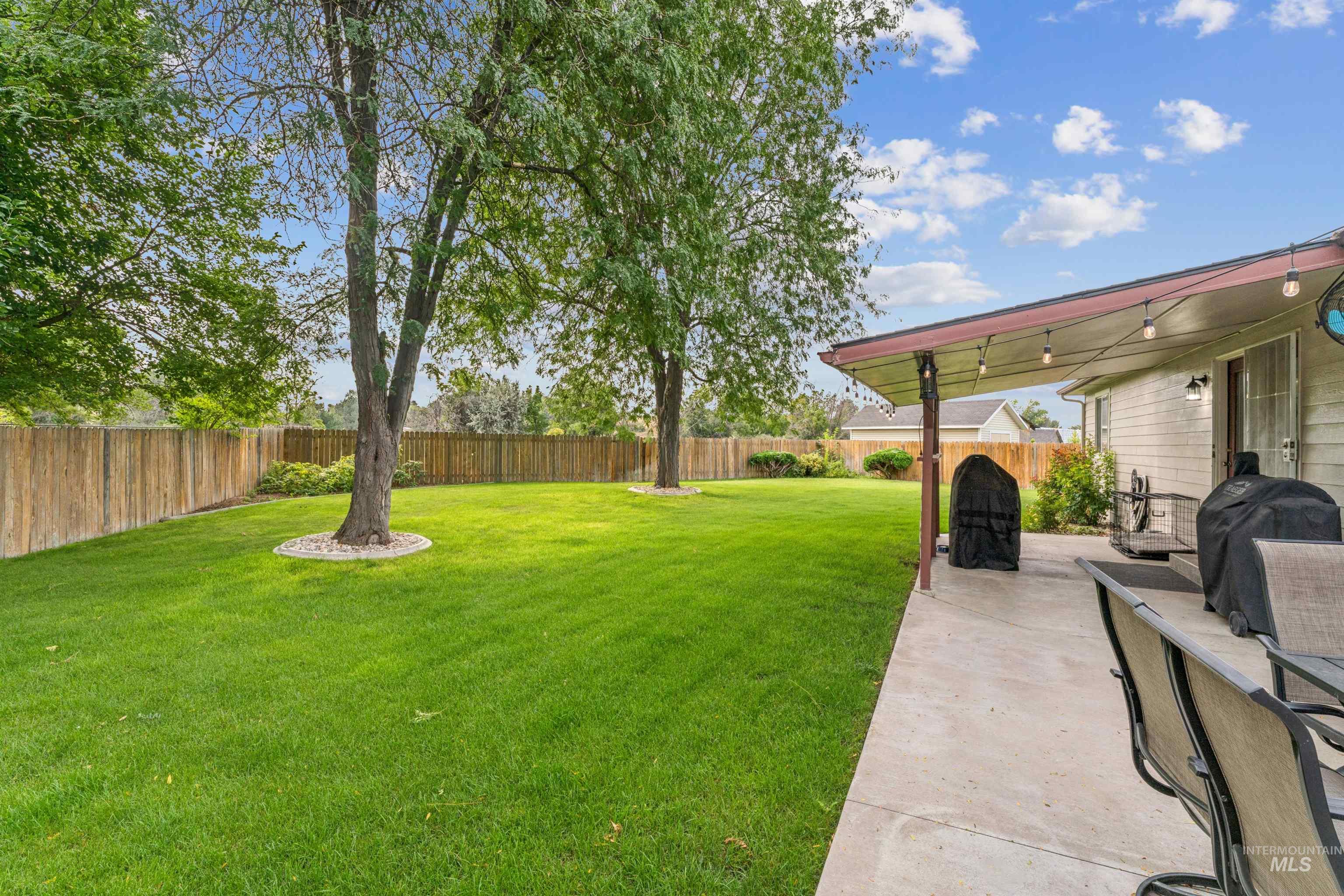 Fenced backyard with a patio area