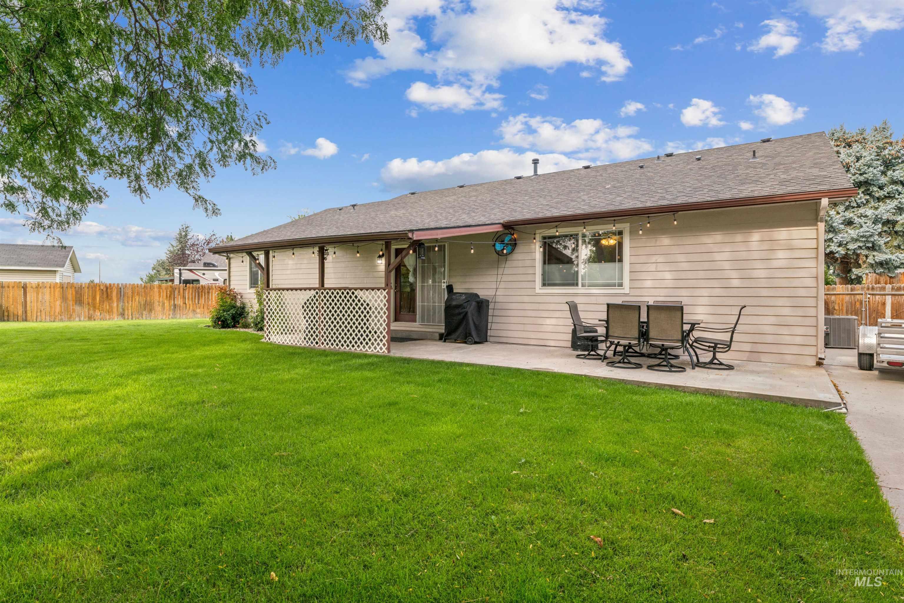 Back of house with a patio and a shingled roof
