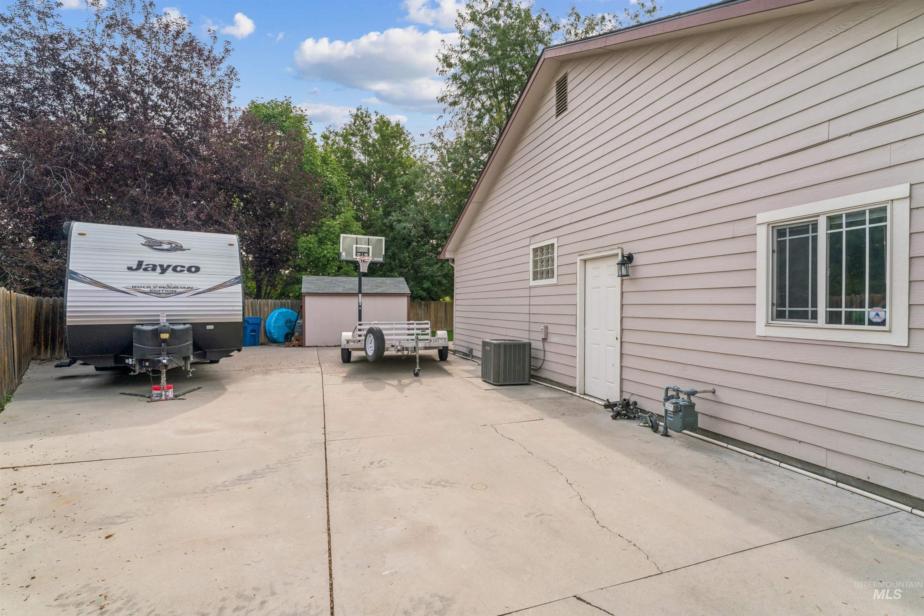 View of patio with a storage unit