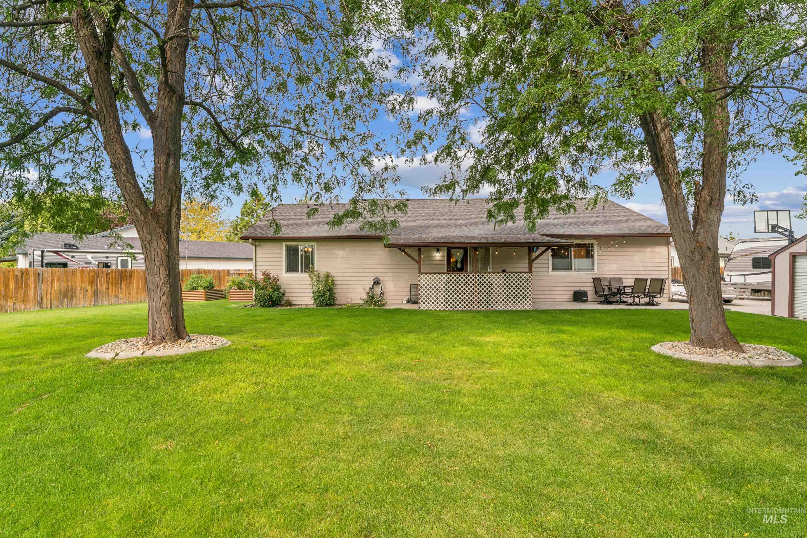 Rear view of property featuring a patio and a shingled roof