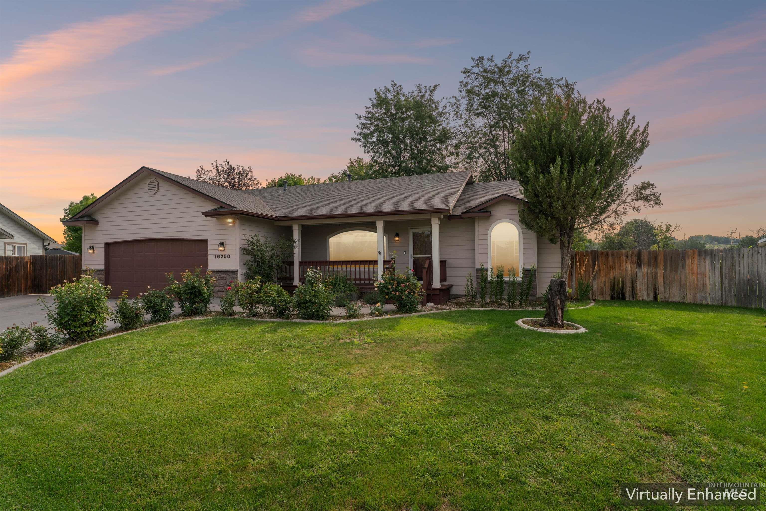 Ranch-style home with covered porch, a garage, and roof with shingles