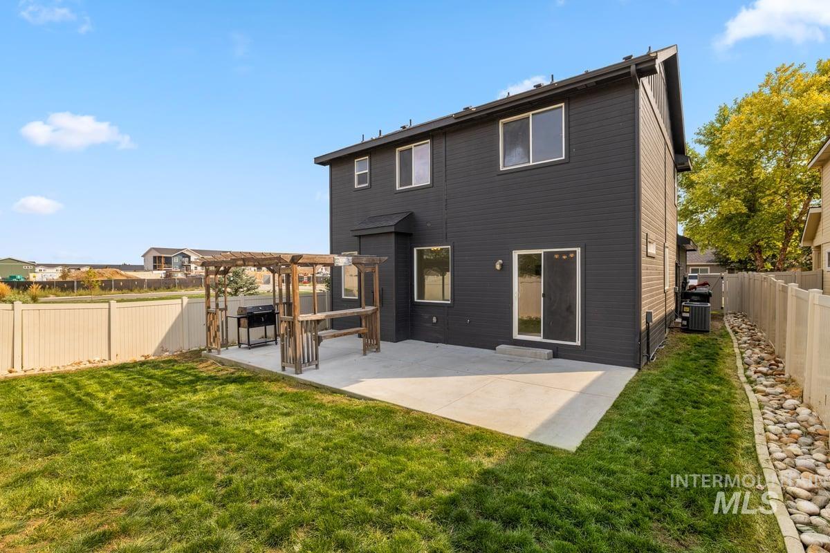 Back of property with a patio, a fenced backyard, and a pergola