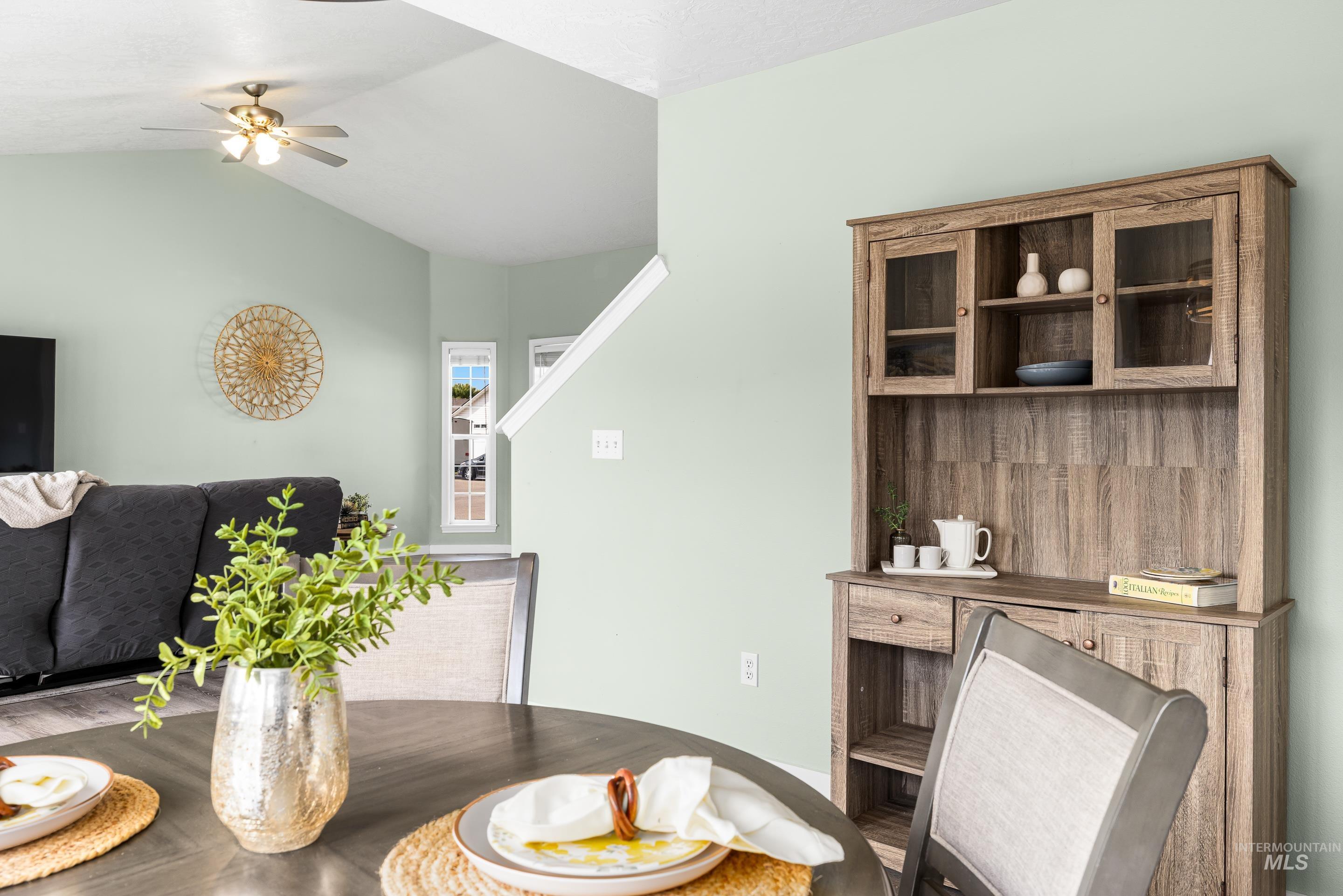 Dining area featuring vaulted ceiling and a ceiling fan