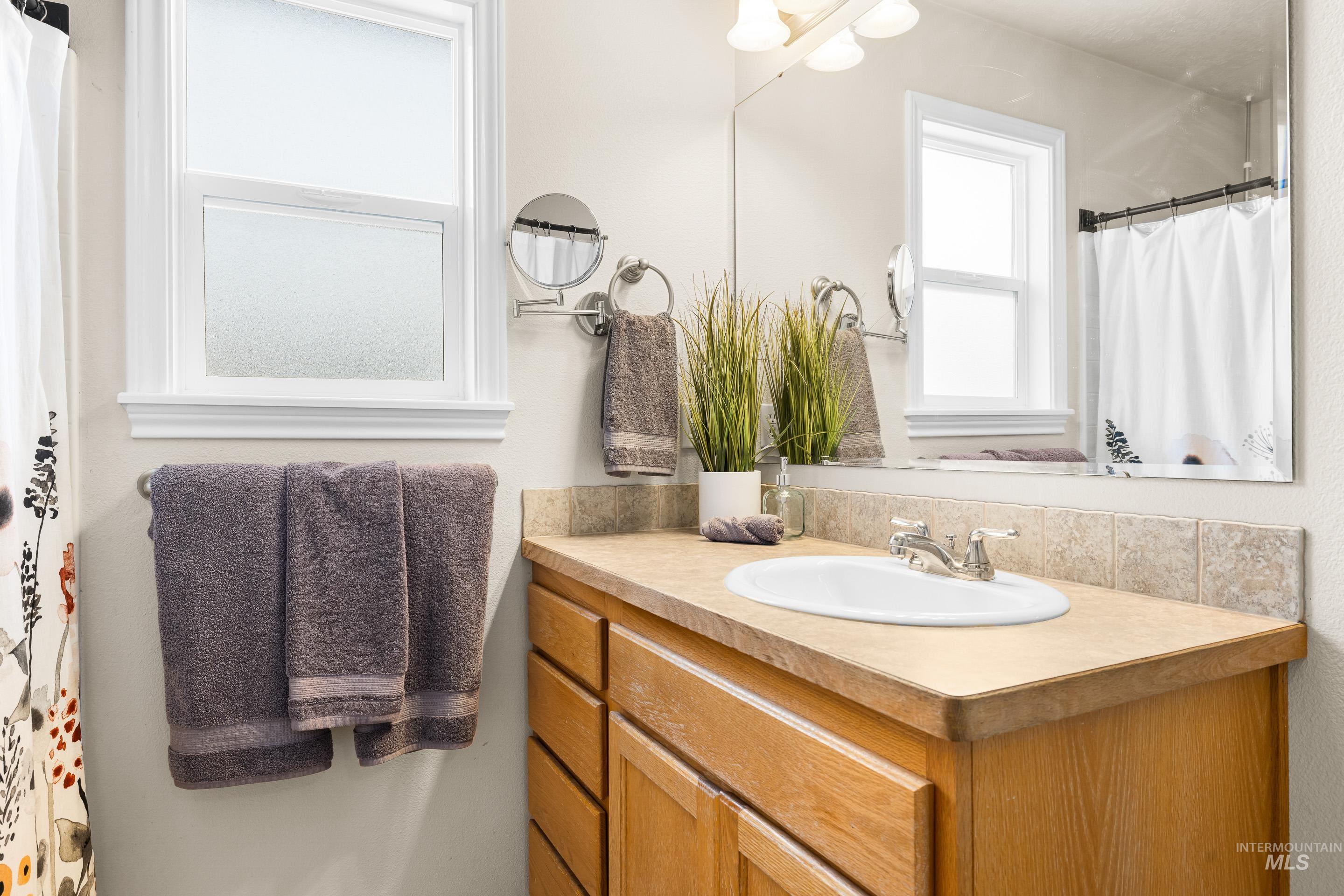 Full bath with vanity and a shower with curtain