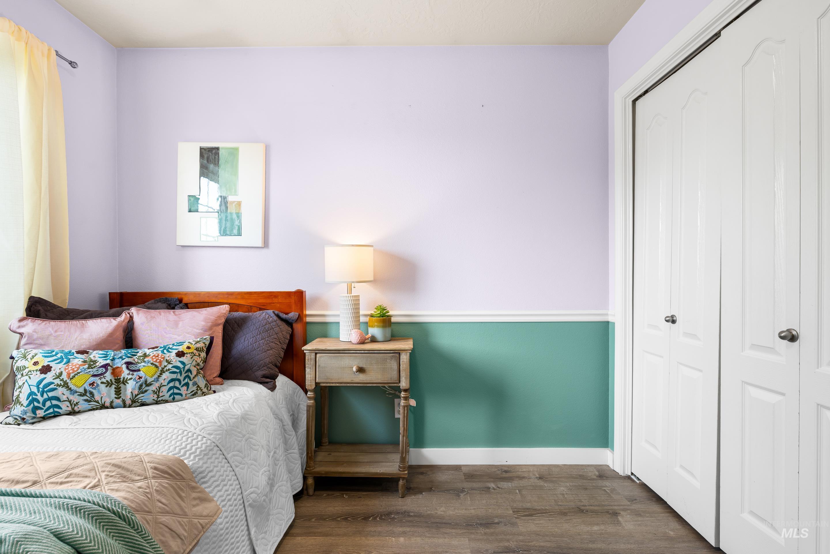 Bedroom featuring wood finished floors and a closet
