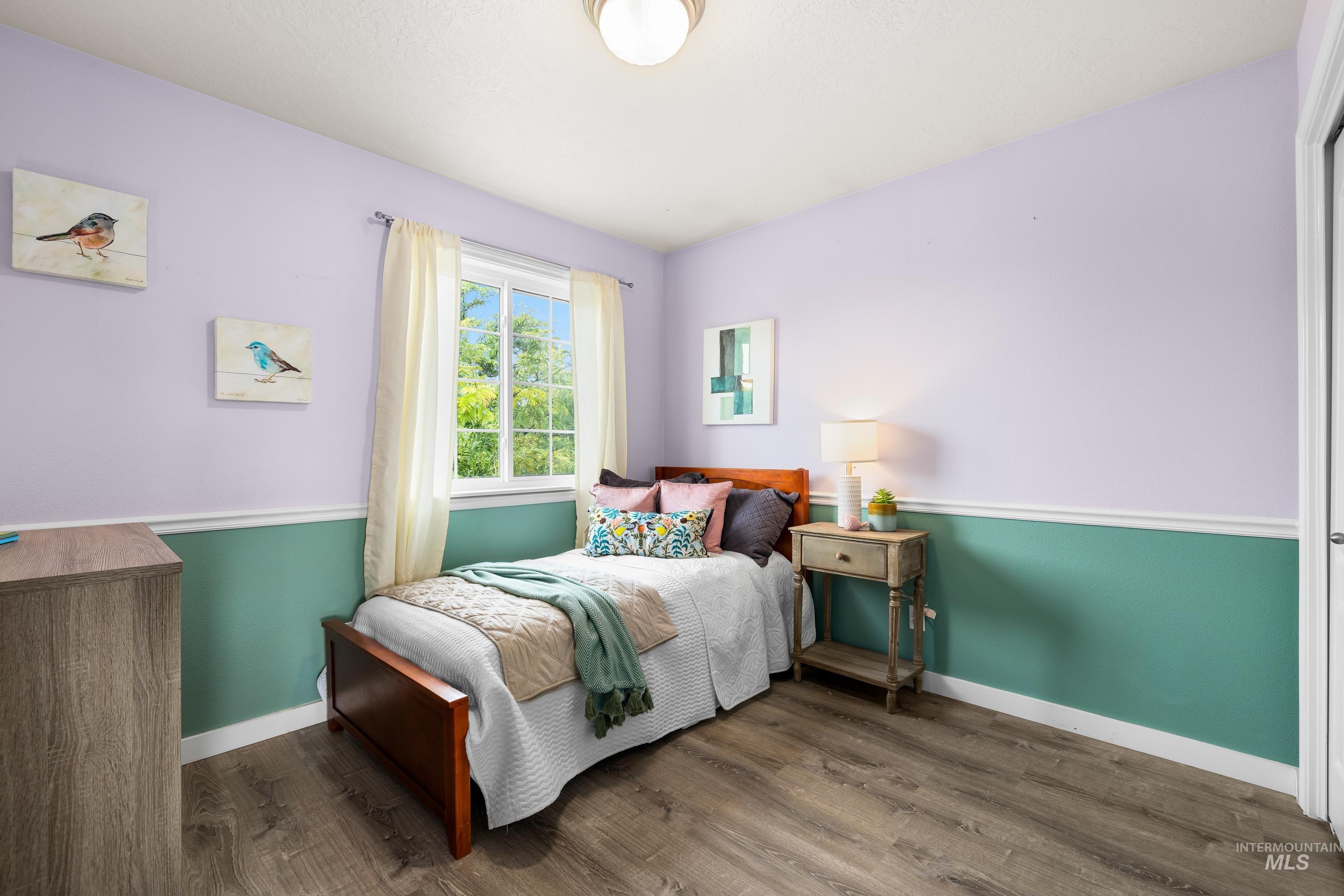 Bedroom featuring dark wood-type flooring
