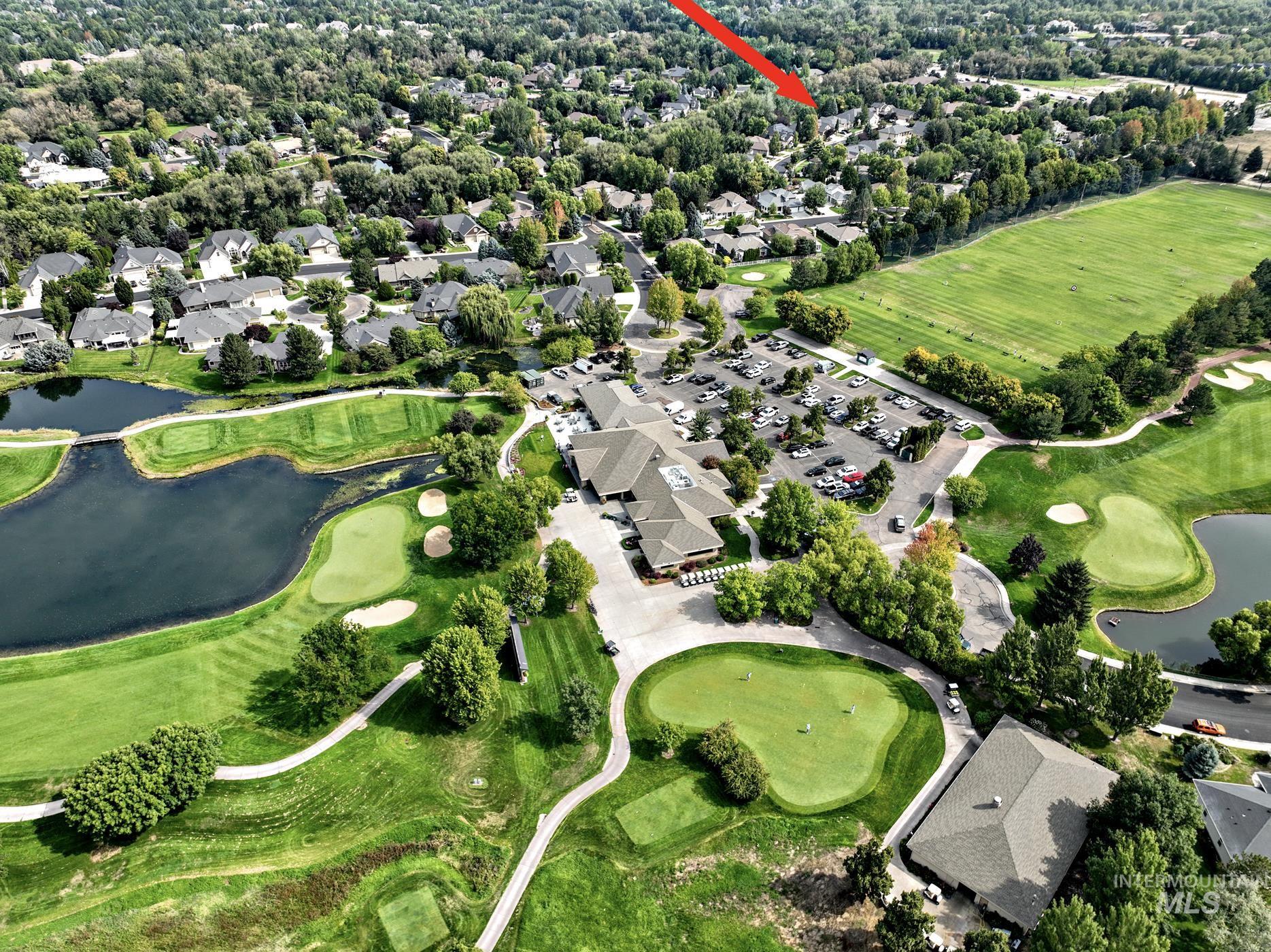 View of property location with a large body of water, a local golf course, and nearby suburban area
