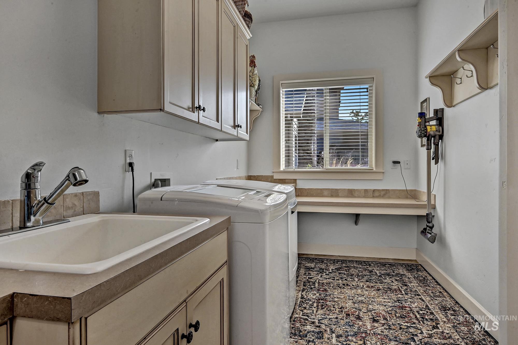 Laundry room featuring washer and clothes dryer and cabinet space