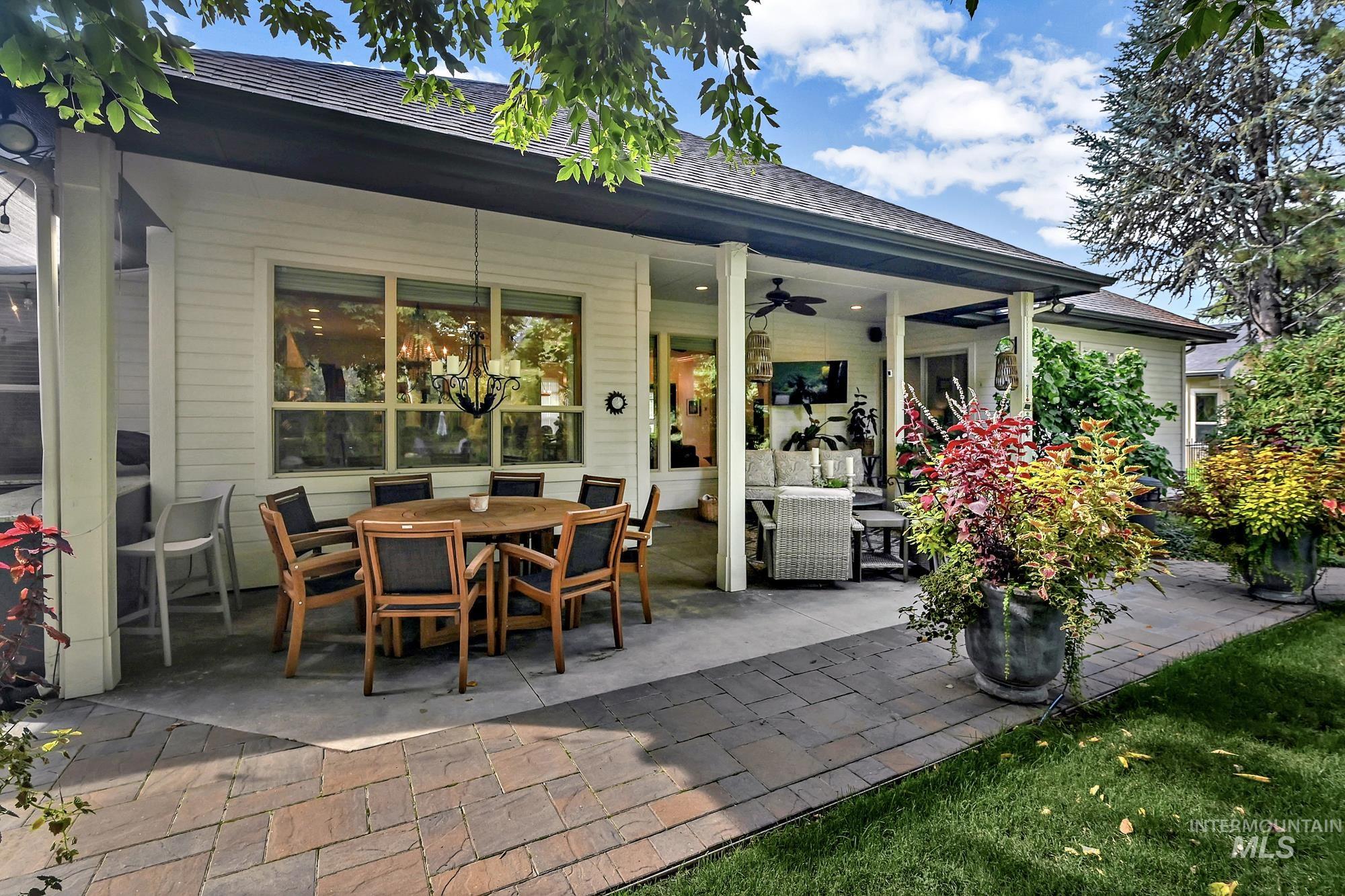 Rear view of property with a patio area, outdoor dining area, ceiling fan, roof with shingles, and an outdoor living space