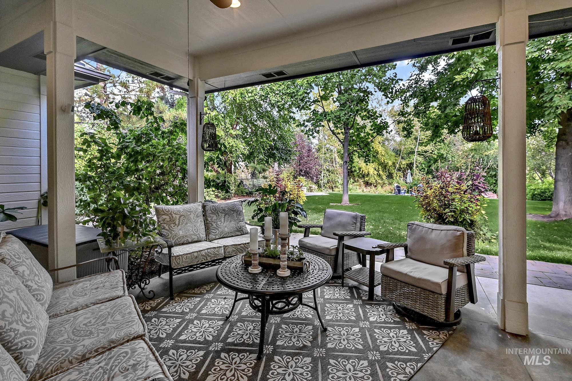 Sunroom / solarium featuring an outdoor living space, a patio area, and a ceiling fan