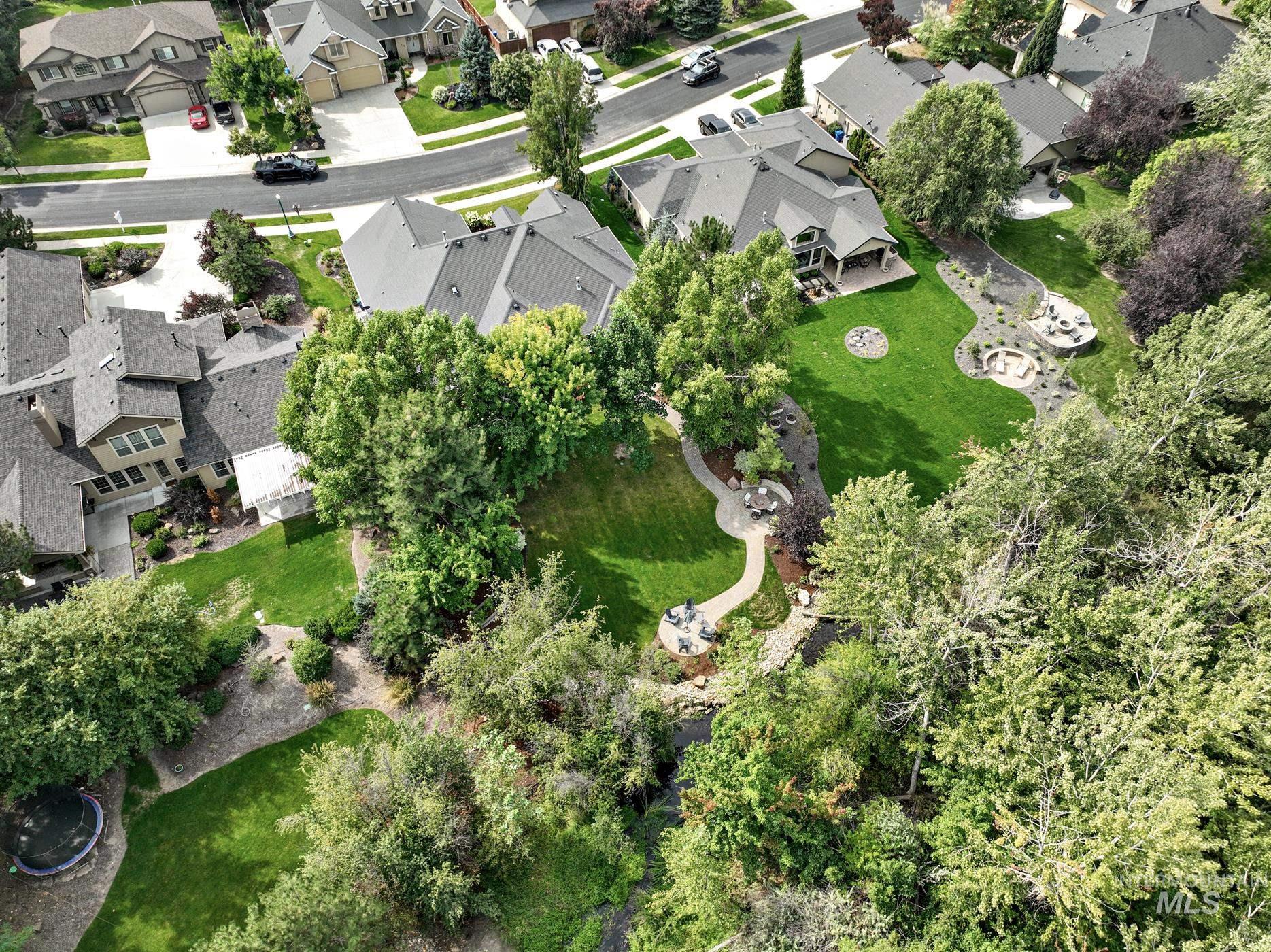 Aerial view of property and surrounding area featuring nearby suburban area