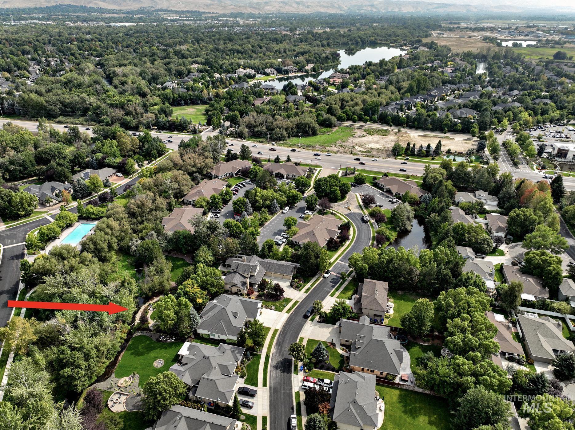 Aerial overview of property's location featuring nearby suburban area and a large body of water