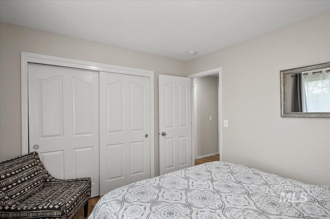 Bedroom with a closet and wood finished floors