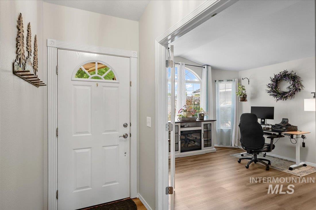 Entryway featuring light wood-type flooring and baseboards