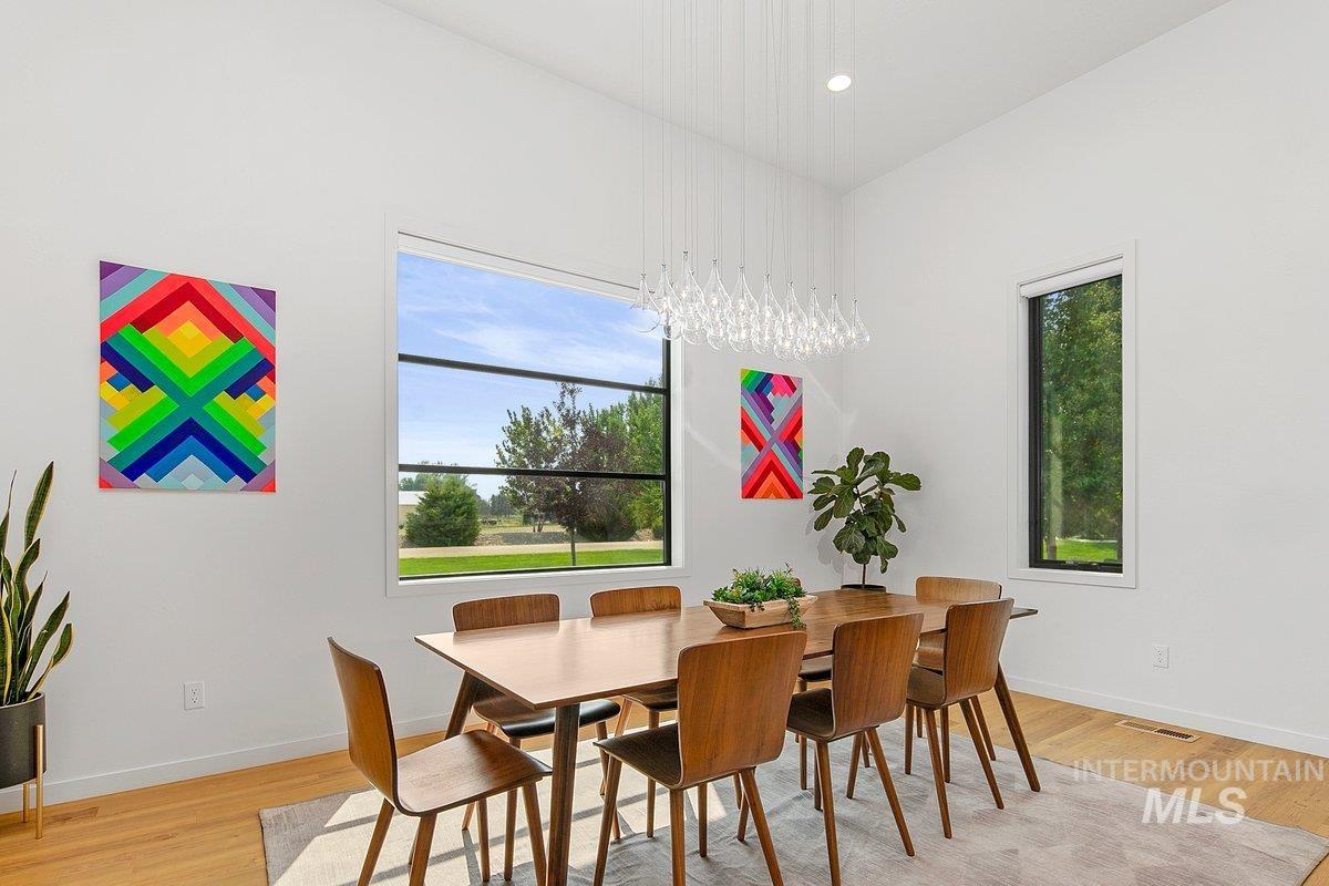 Dining space with light wood finished floors and recessed lighting