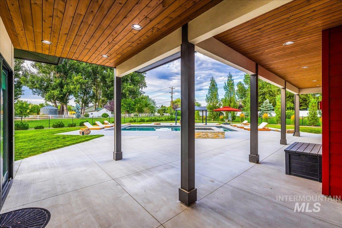 View of patio / terrace with a pool with connected hot tub